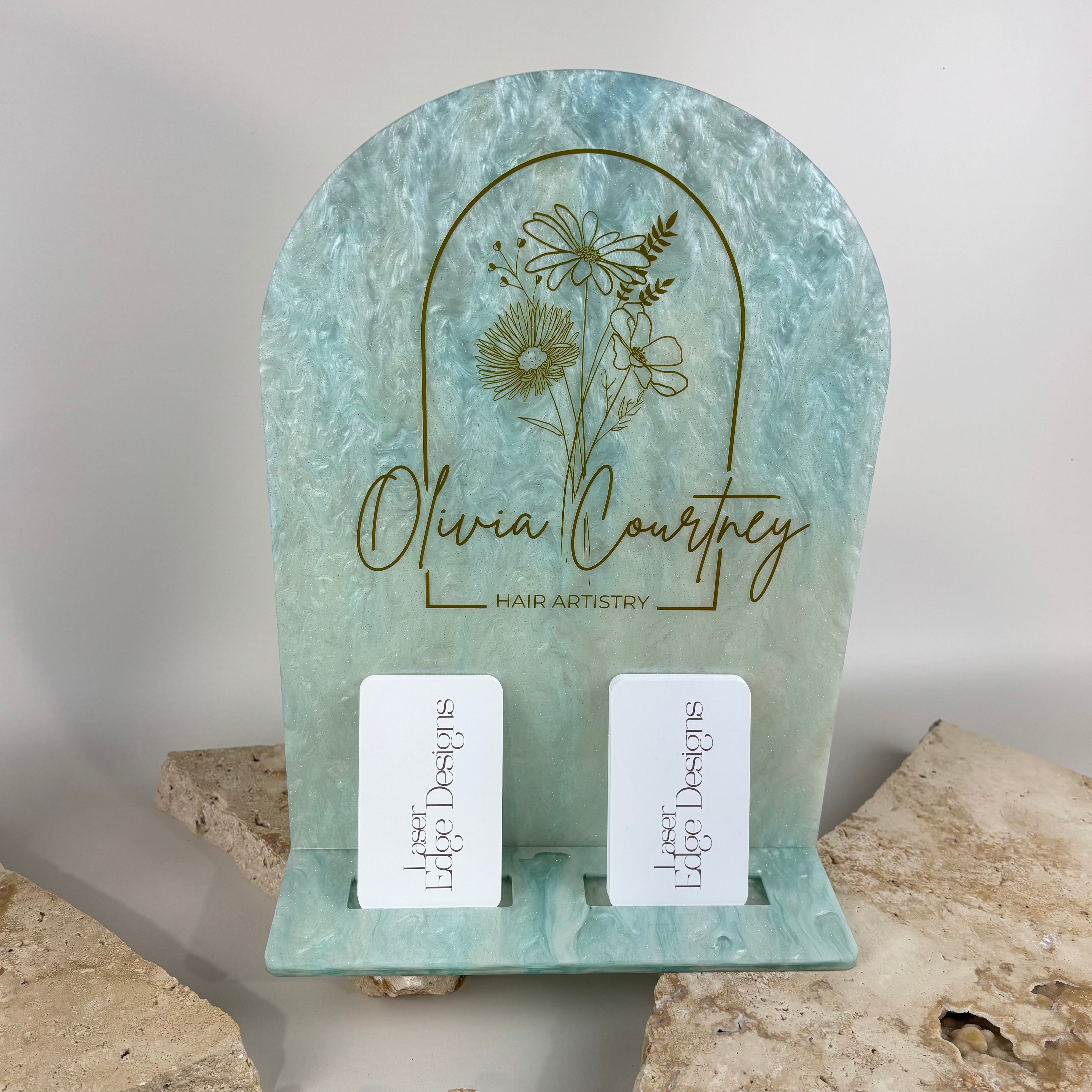 Custom pearl mint green acrylic NFC business station with engraved floral logo and dual business card holder for hair salon, beauty salon, lash artist, brow studio, barber, spa or small business reception desk.