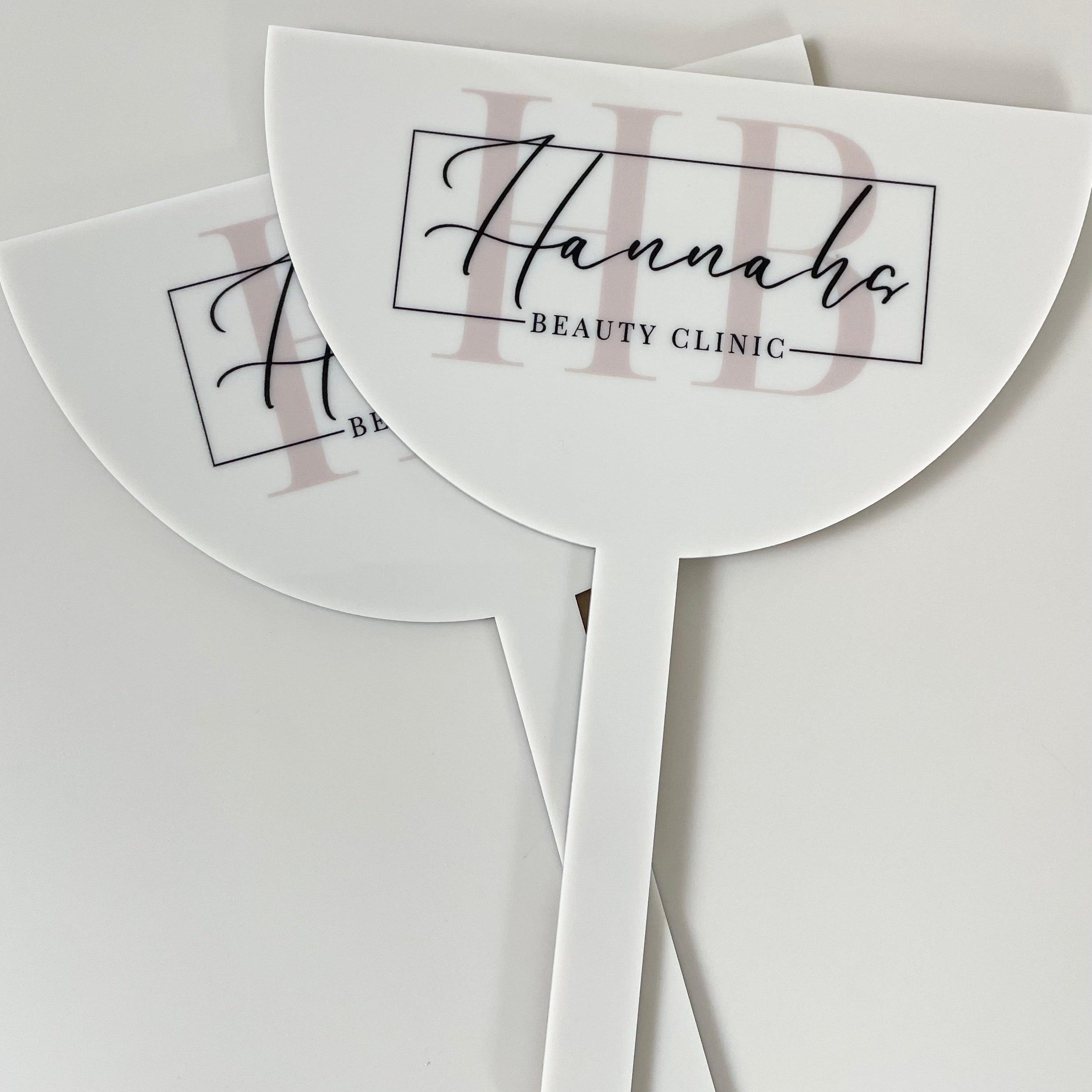 White branded face shield with hannahs Beauty clinic logo
