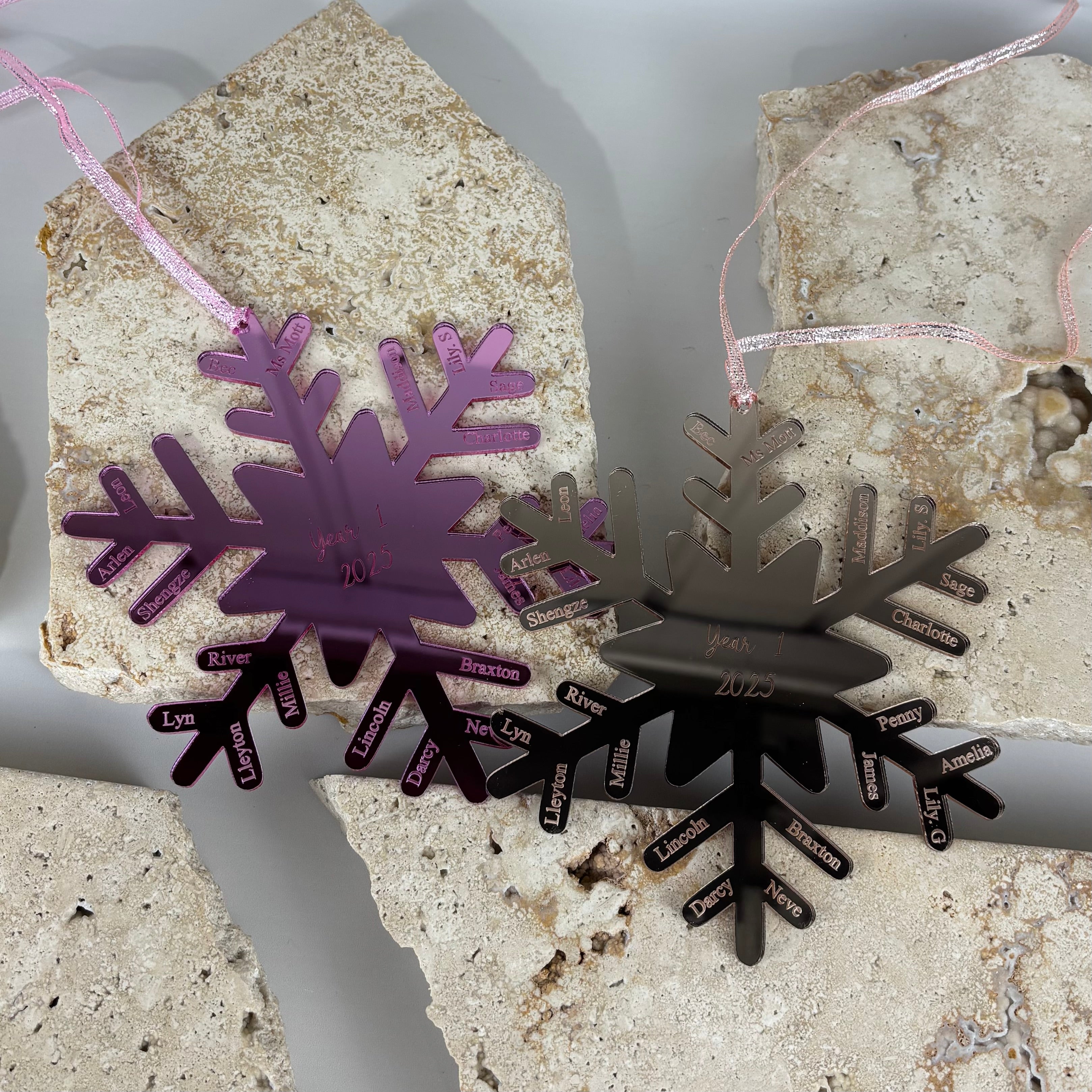 custom acrylic snowflake christmas baubles in pink and rose gold on stone backdrop, engraved with year 1 2025 and student names, personalised classroom ornaments end of year teacher gift australia made