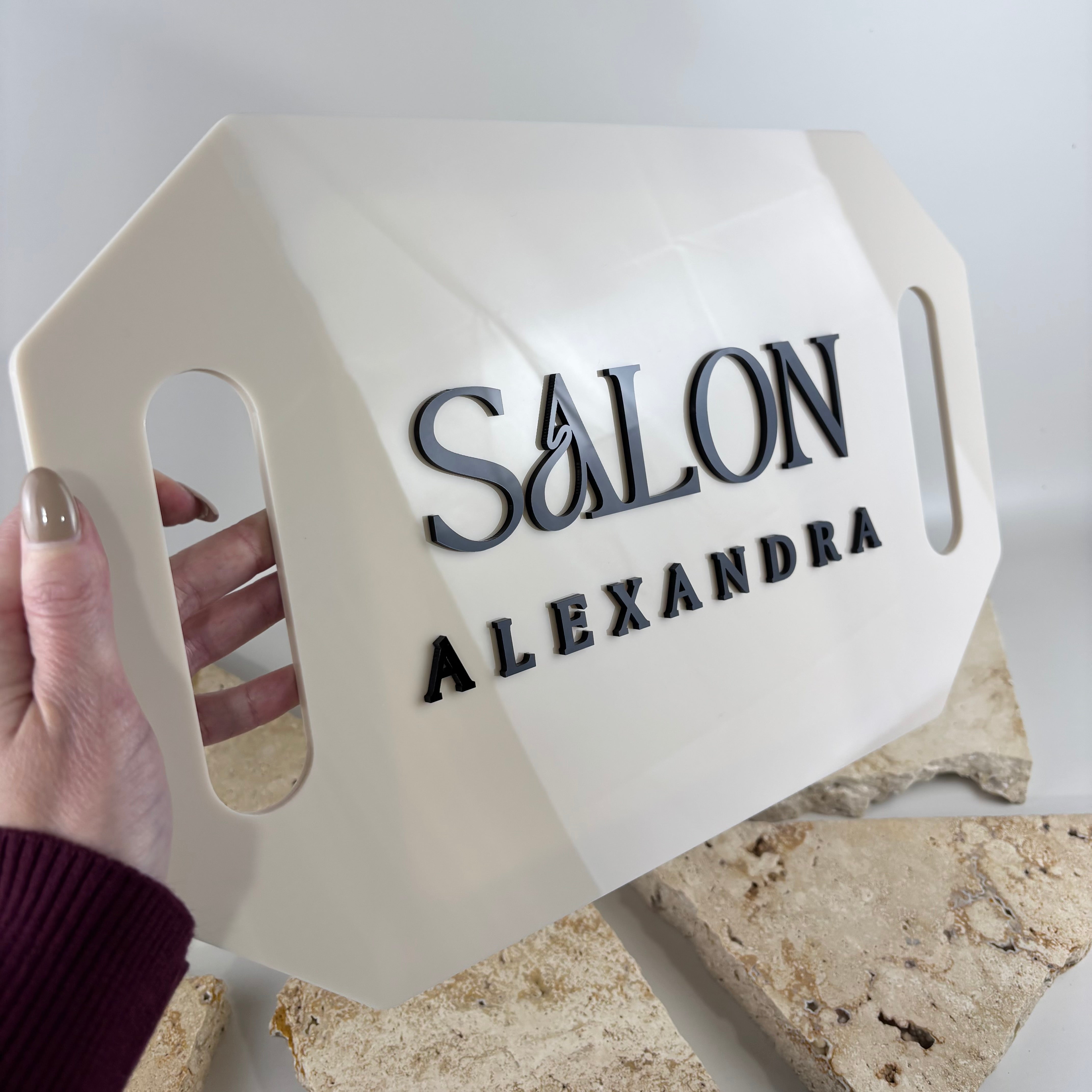 Custom acrylic hairdressing mirror with personalised salon branding and raised 3D black lettering. Modern handheld salon mirror in a neutral cream finish, designed for hairdressers, beauty salons and makeup artists. Lightweight acrylic mirror ideal for client reveals, salon photos, social media content and professional business branding in Australia.