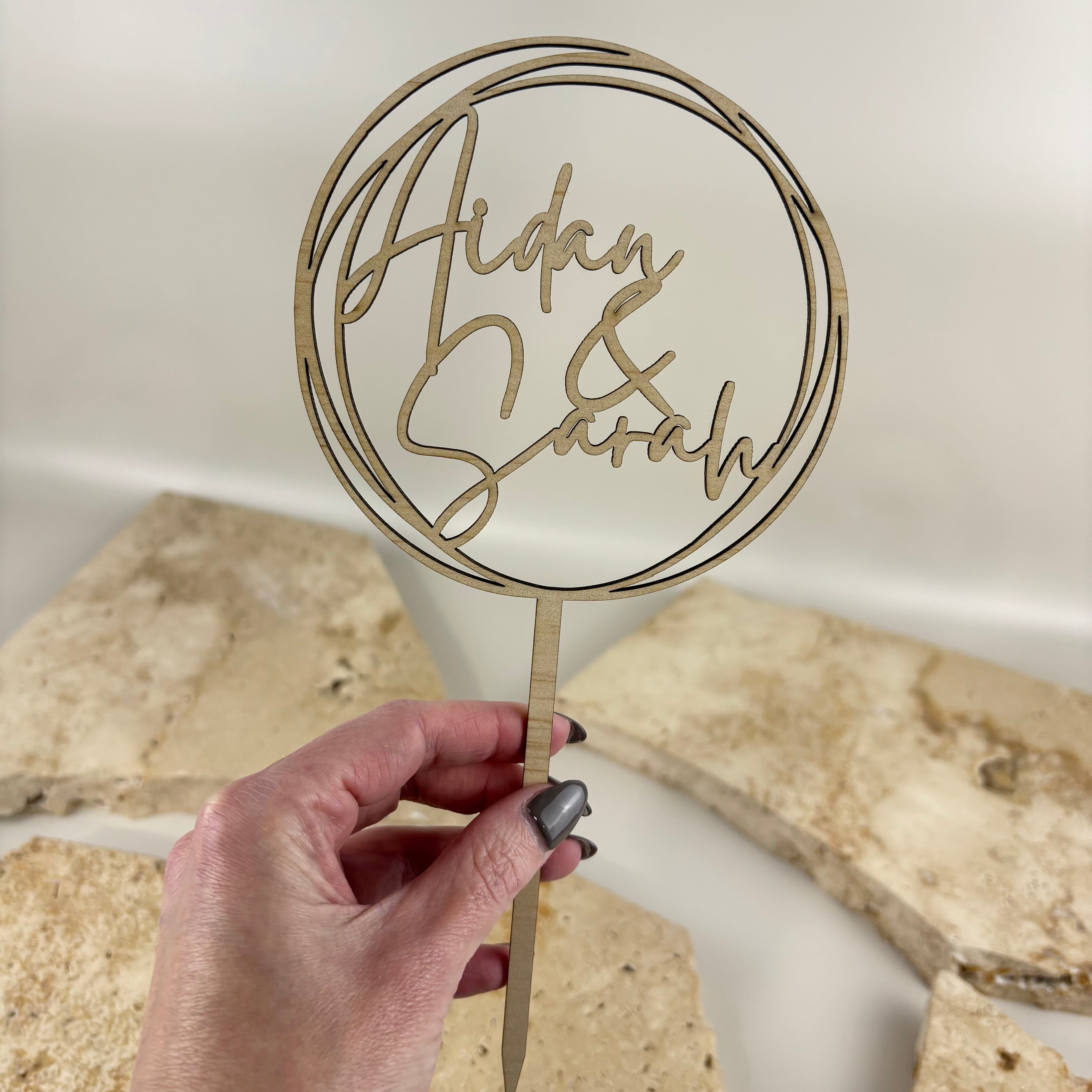 Personalised engraved timber cake topper with custom names, round wooden wedding cake topper for weddings, engagements, bridal showers, anniversaries and special celebration cakes.