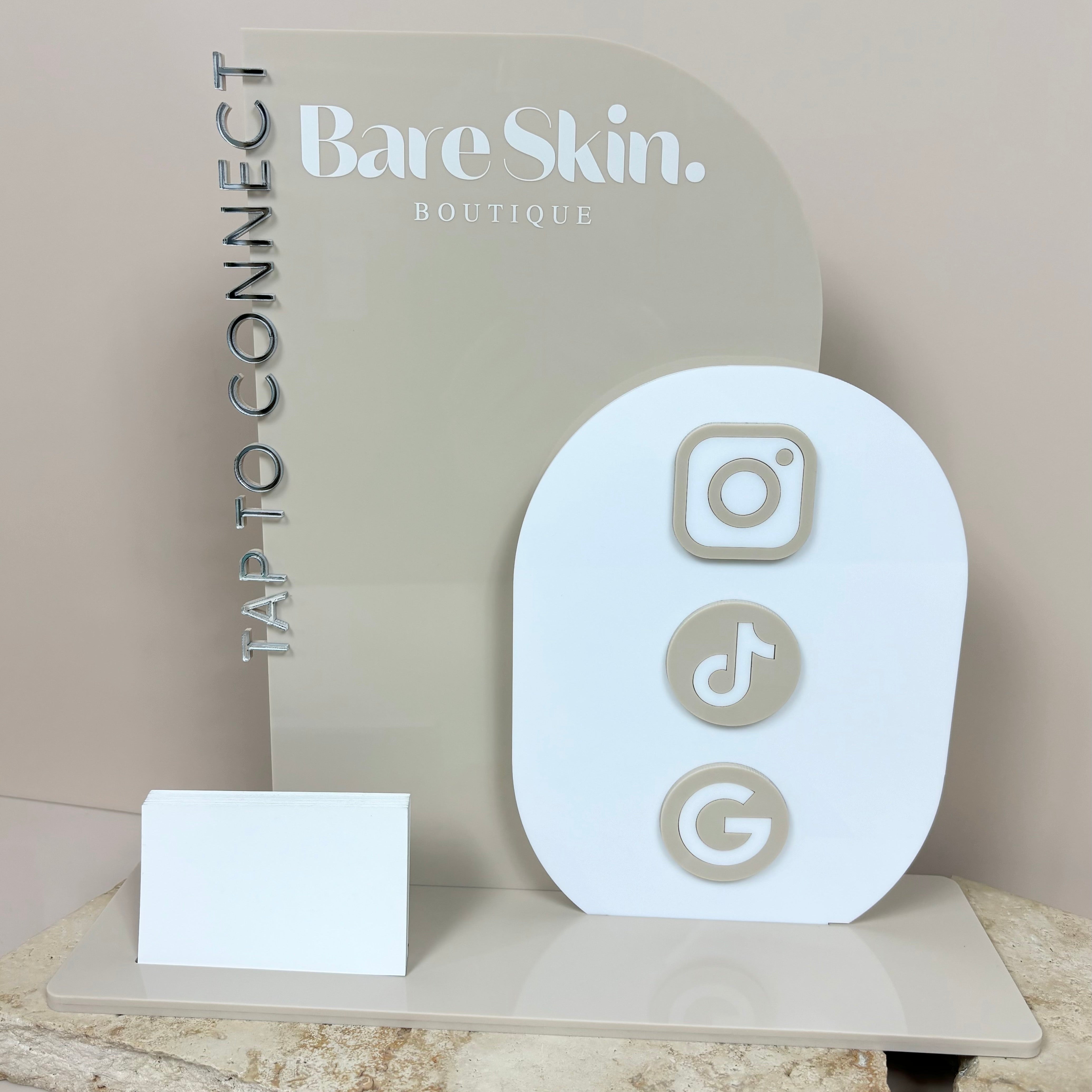 White NFC tap to connect display for BareSkin with TikTok, Instagram, and Google icons