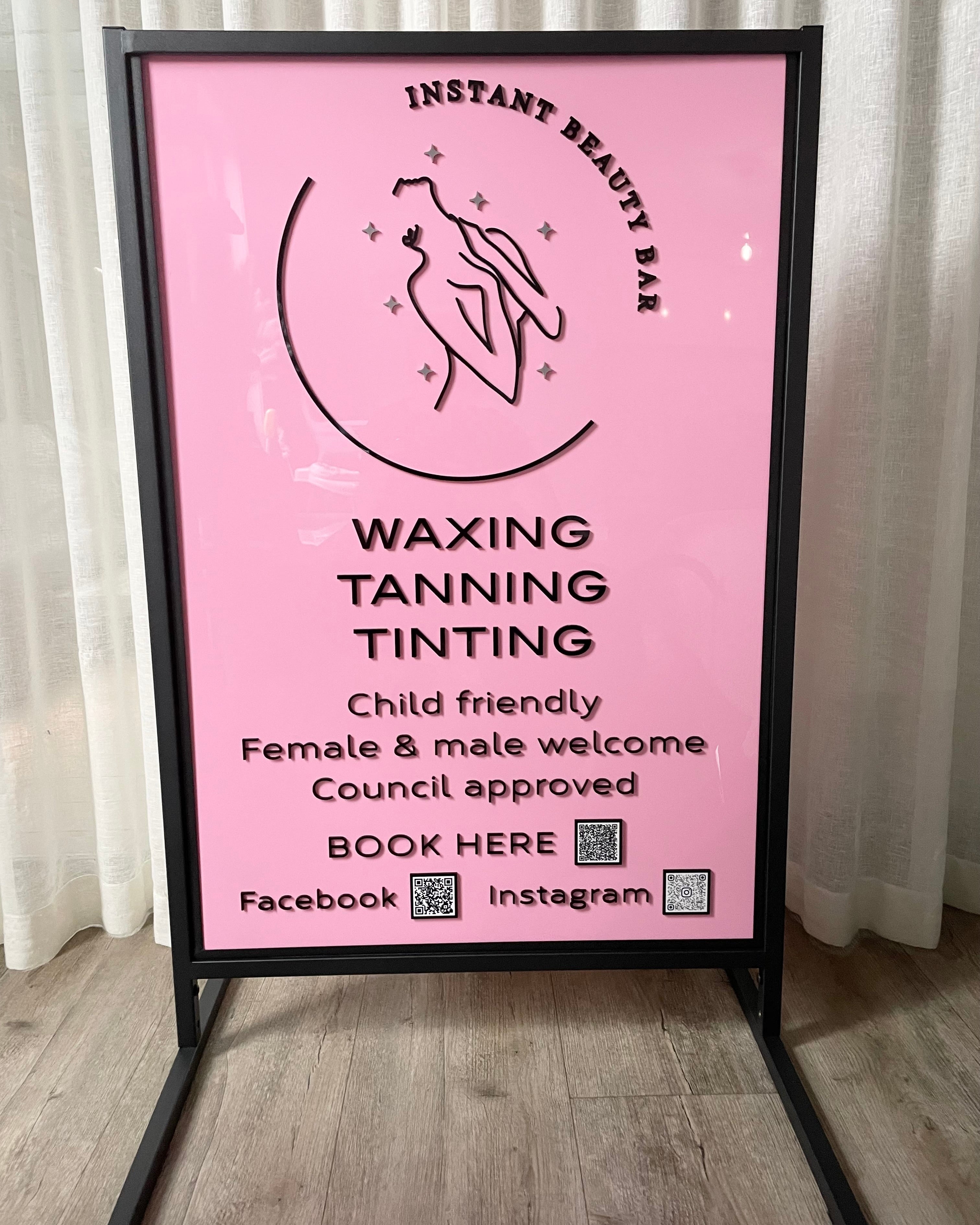 Pink branded T frame advertising stand for waxing and tanning