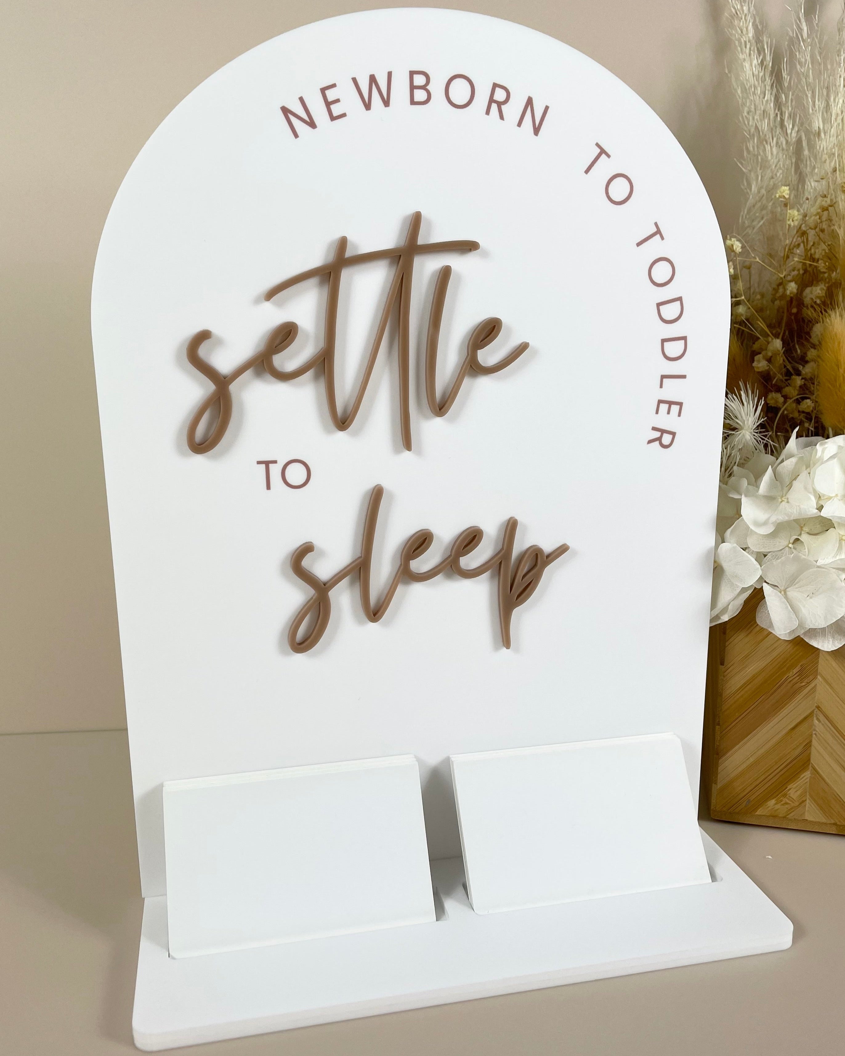 Custom display stand with wood-look logo and double card slots for Settle to Sleep