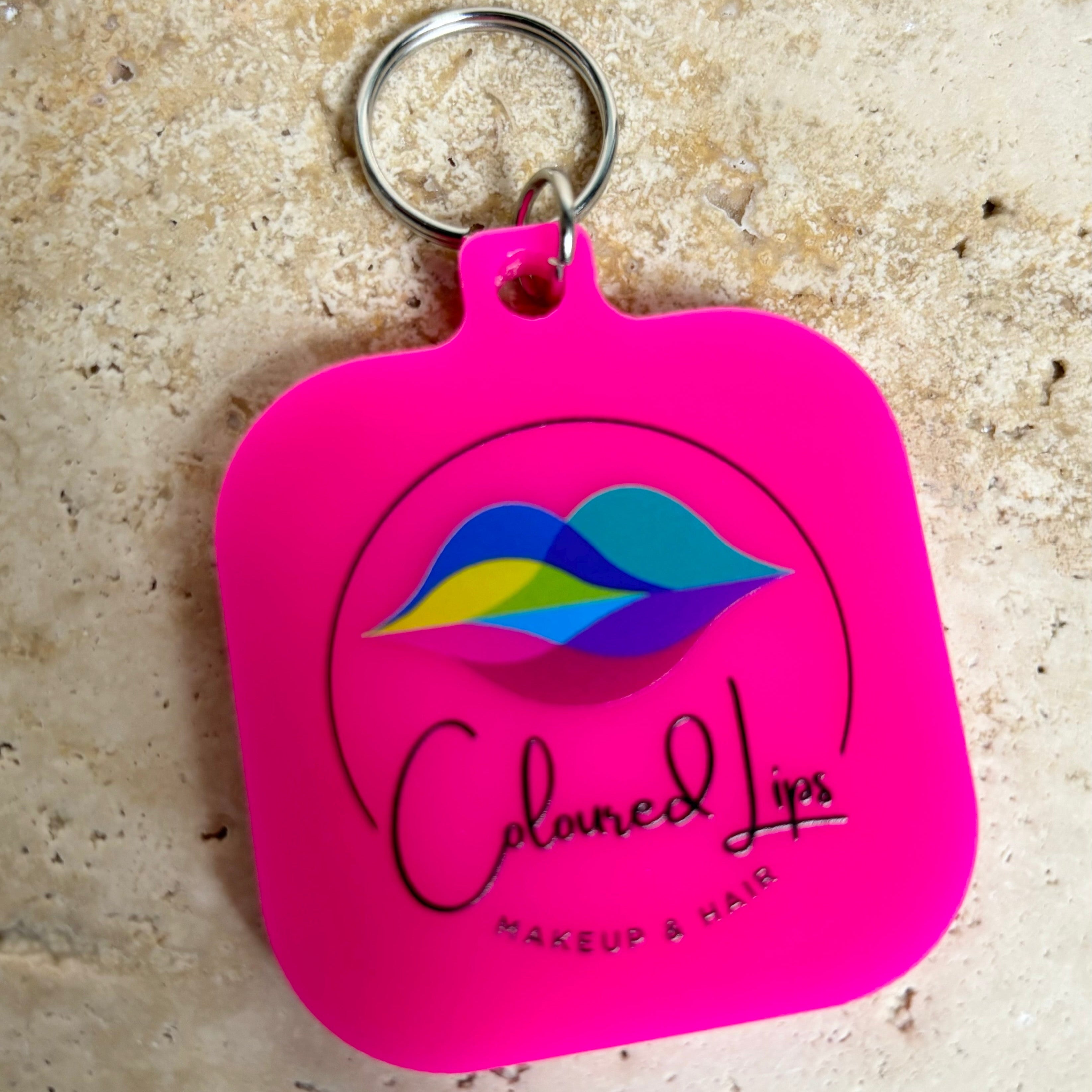 Bright pink NFC tag keychain with custom beauty salon logo