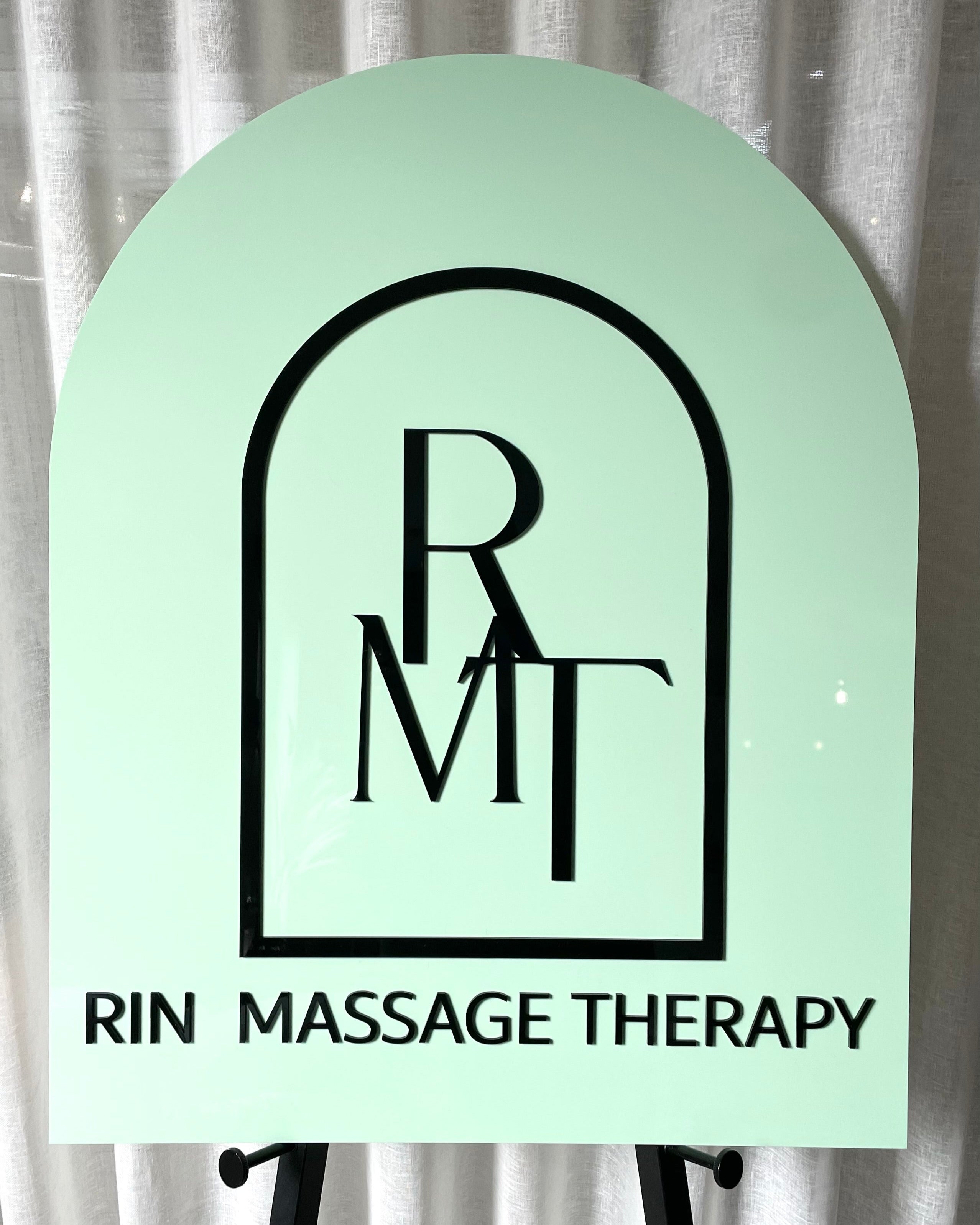 Mint green arch sign for massage therapy studio