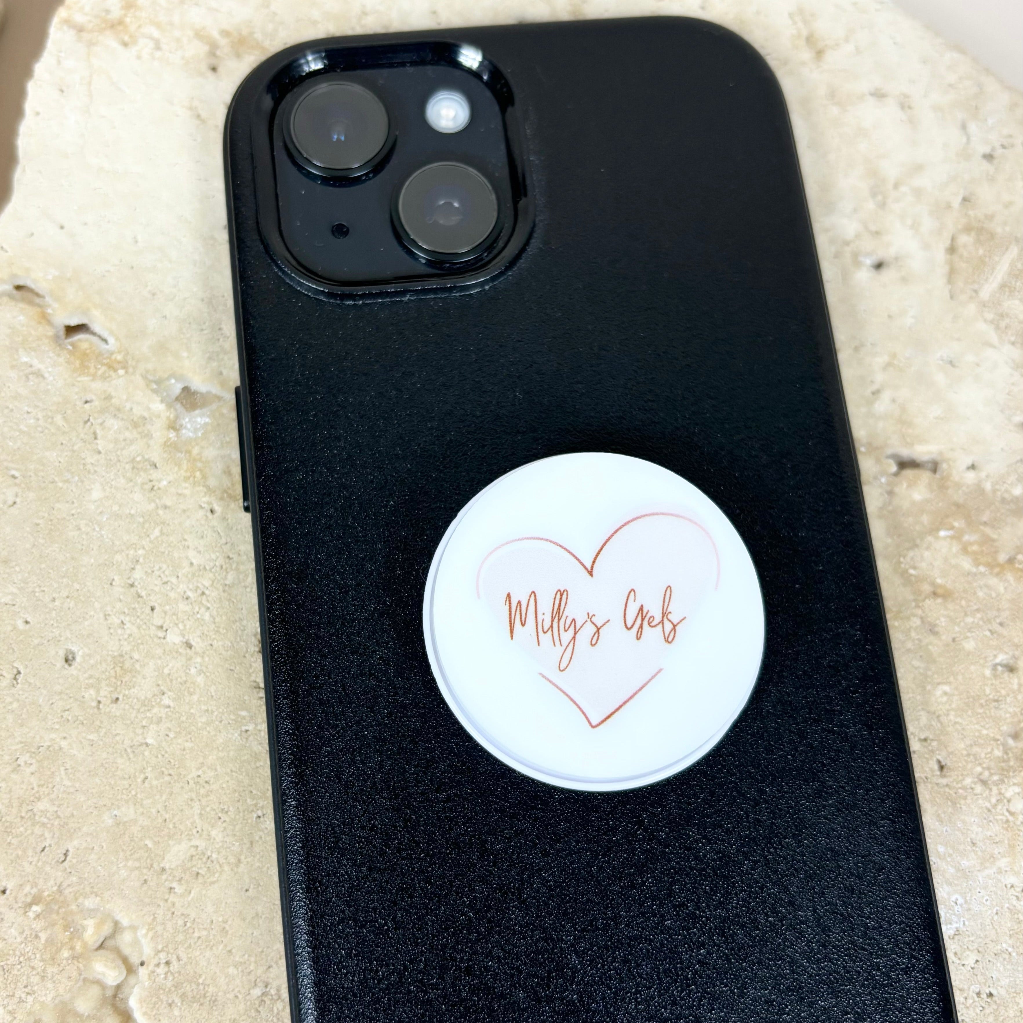 Personalised phone grip with custom logo on black mobile phone