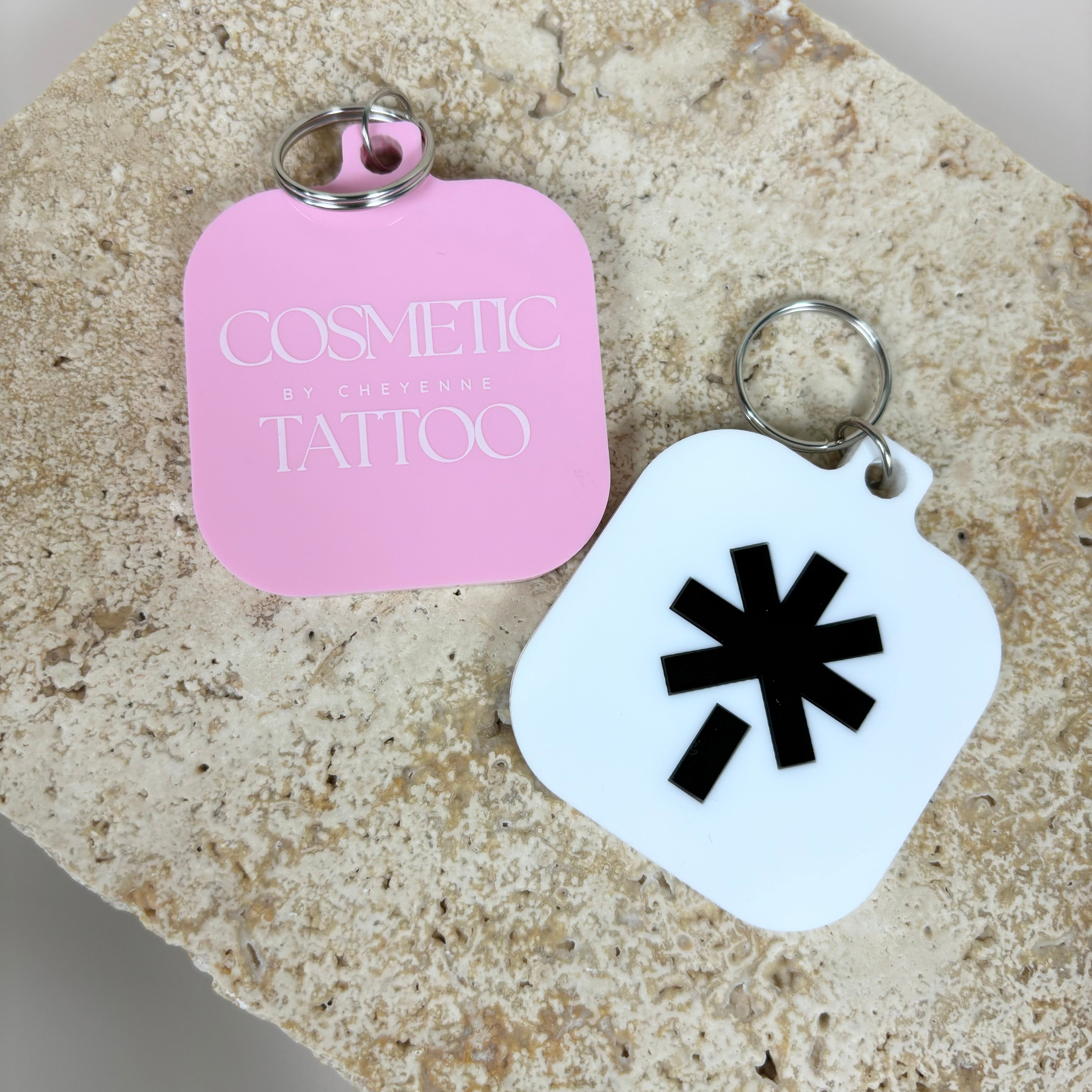 Custom pastel pink and white NFC keychains with minimalist branding