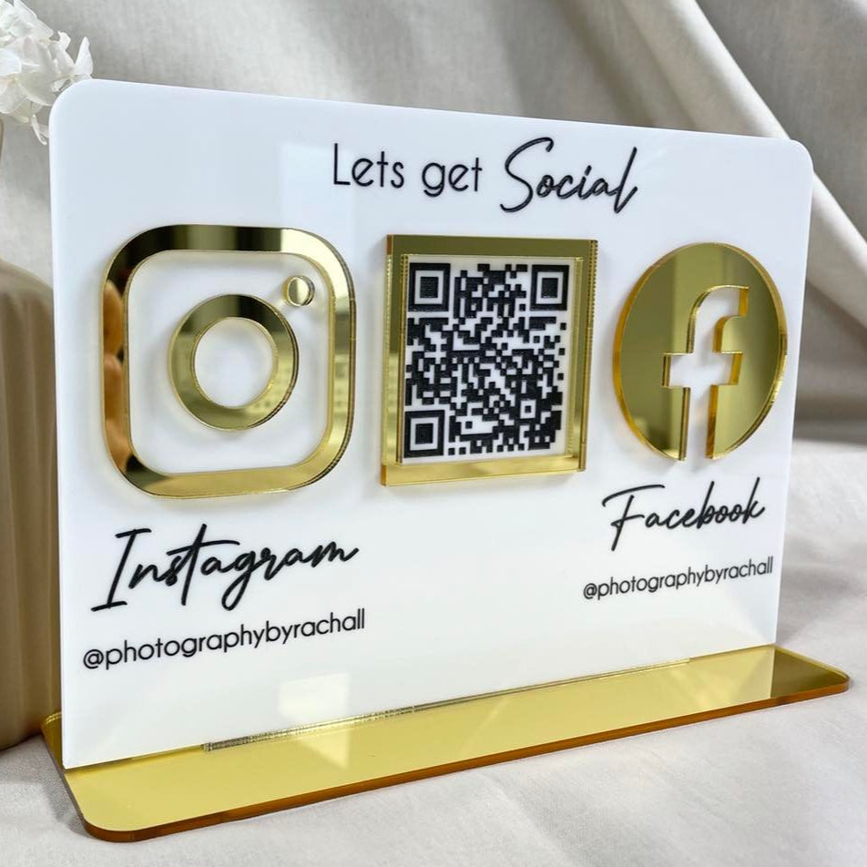 Freestanding acrylic business sign with Instagram and Facebook QR codes on gold base