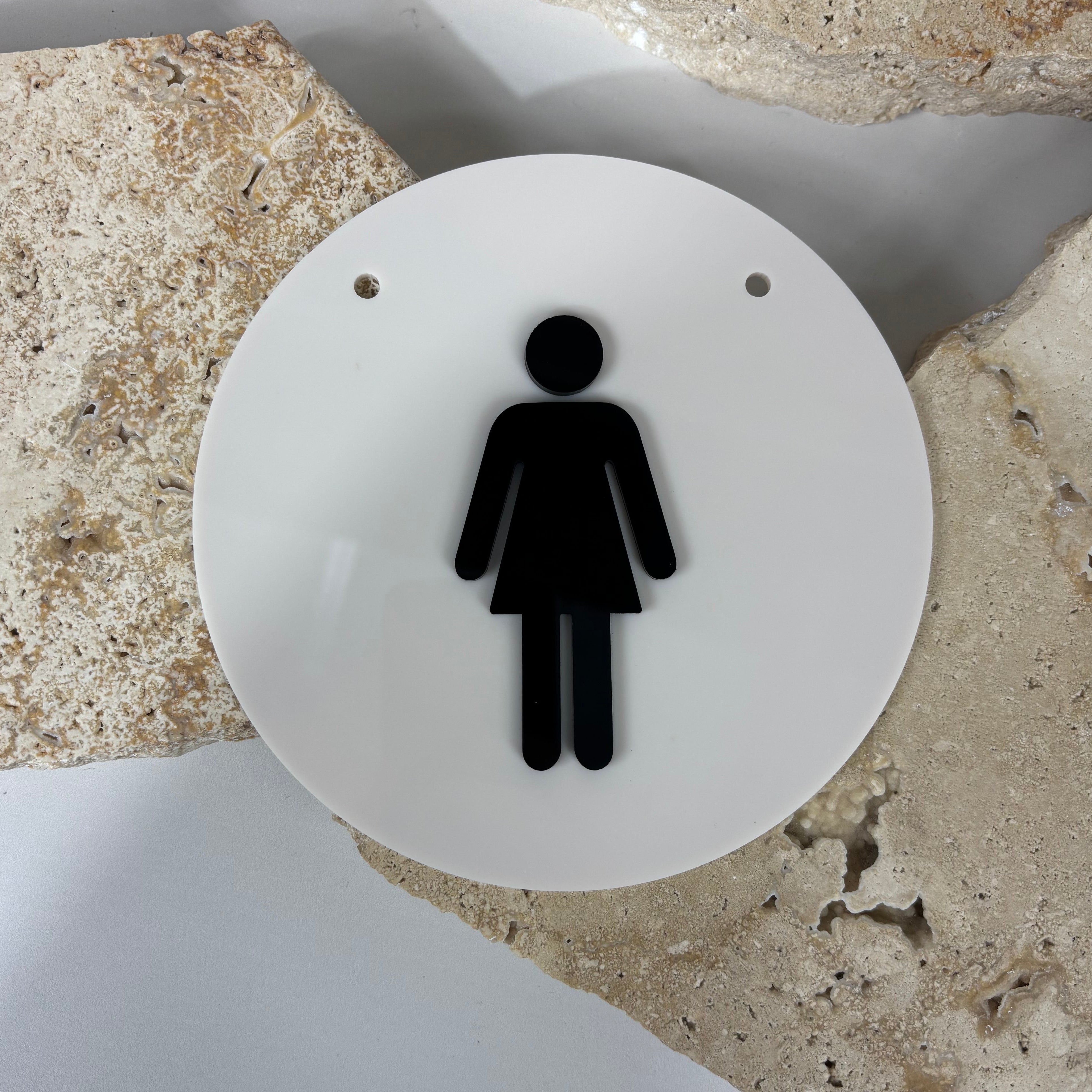 Female toilet sign made from white acrylic with raised black female icon, round bathroom sign for salon, clinic or commercial restroom