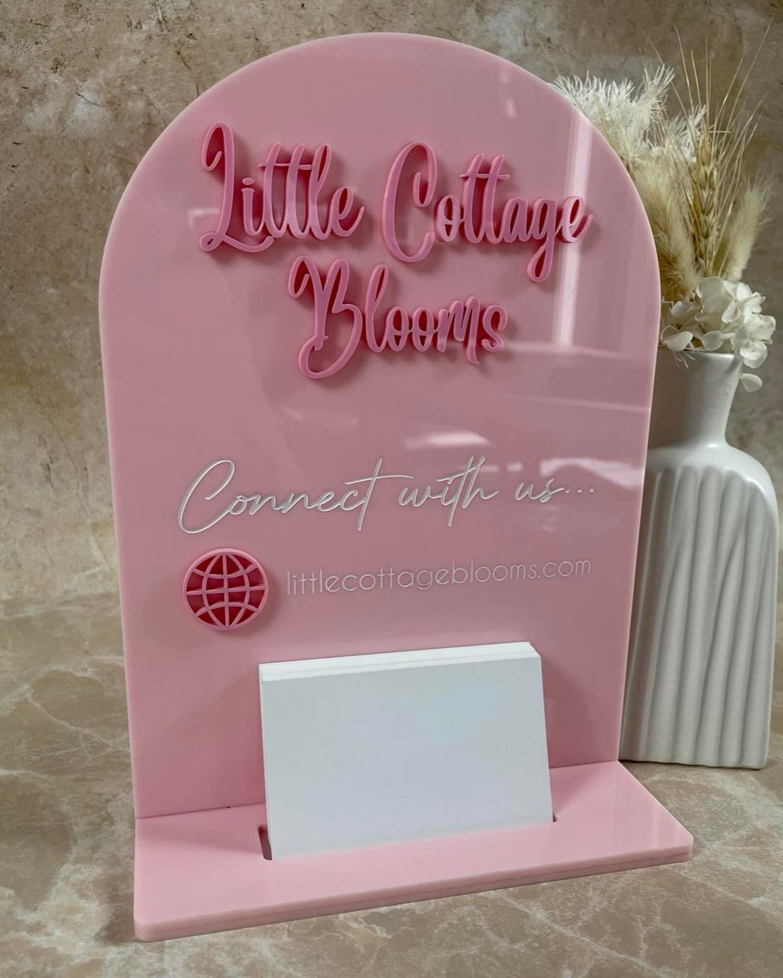 Pink acrylic business card holder with logo and Instagram icon