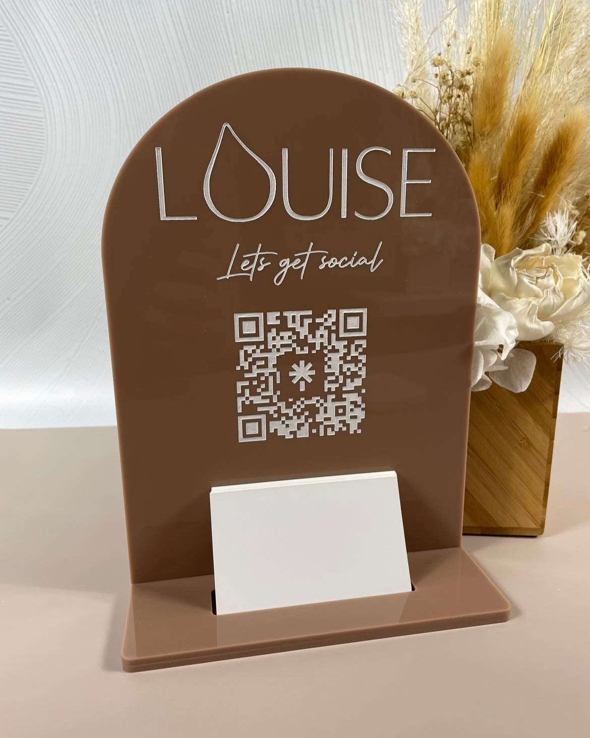 Brown card stand with Louise QR code and branding