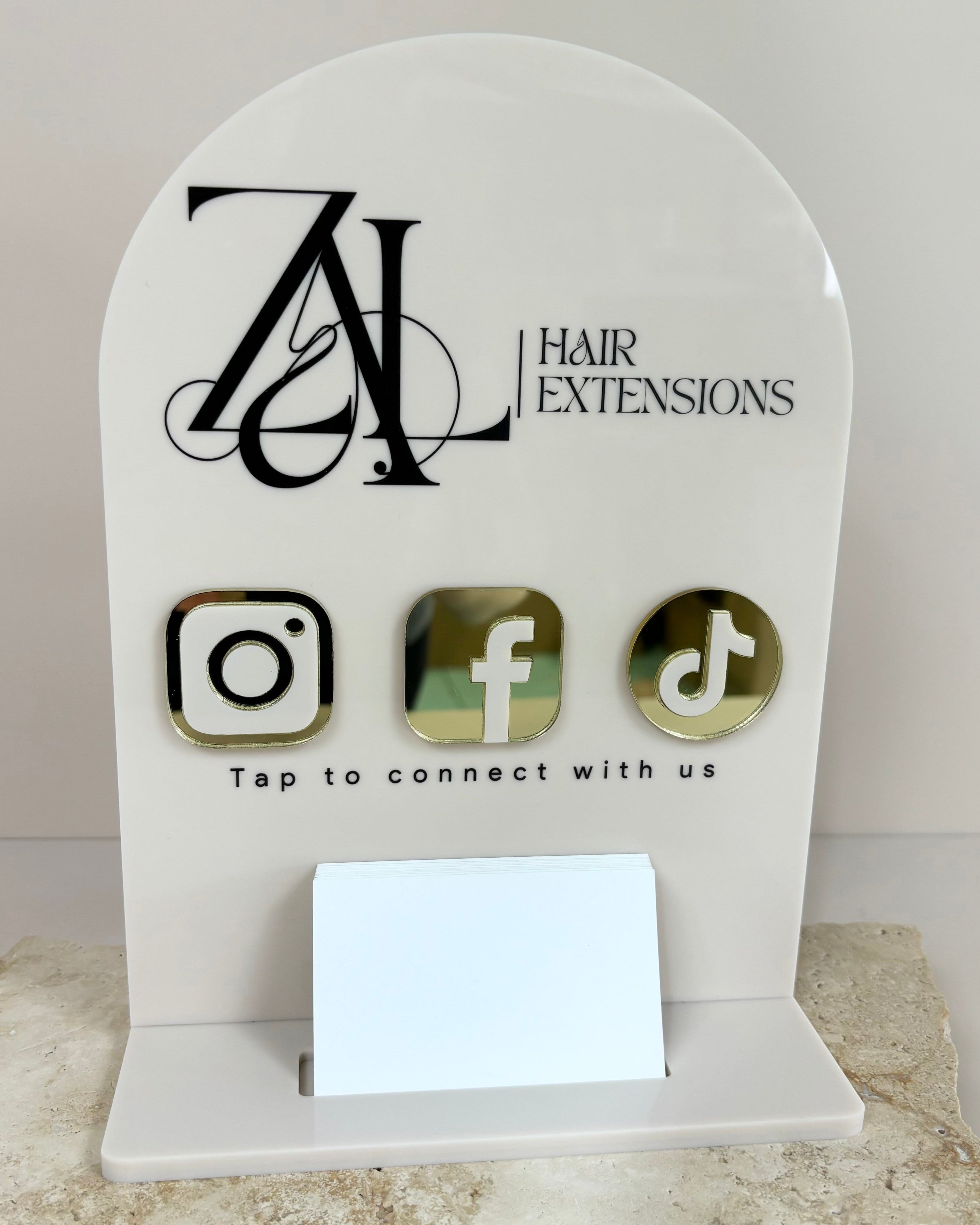NFC card holder with AL Hair Extensions logo and icons for Instagram, Facebook and TikTok on a neutral acrylic base.