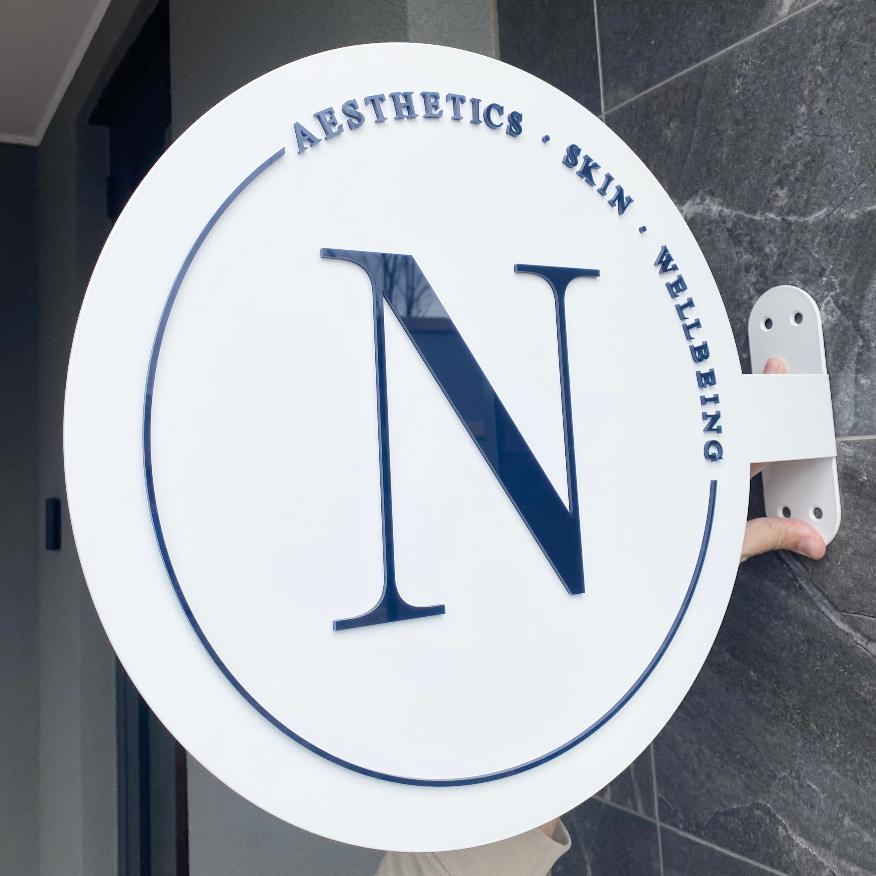 Modern letter N business round blade sign