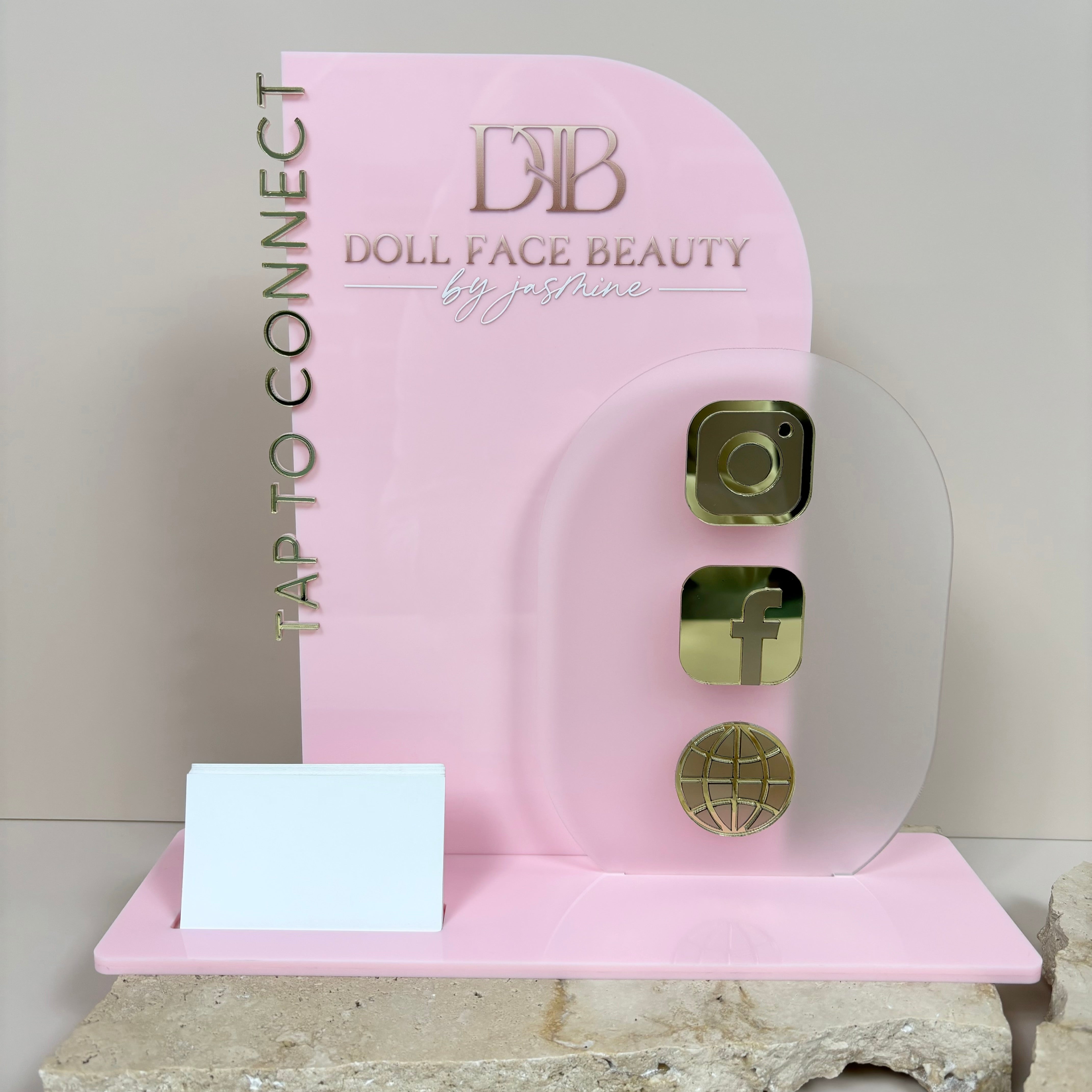 Pink NFC tap to connect display with gold tap buttons for DB Local Face Beauty