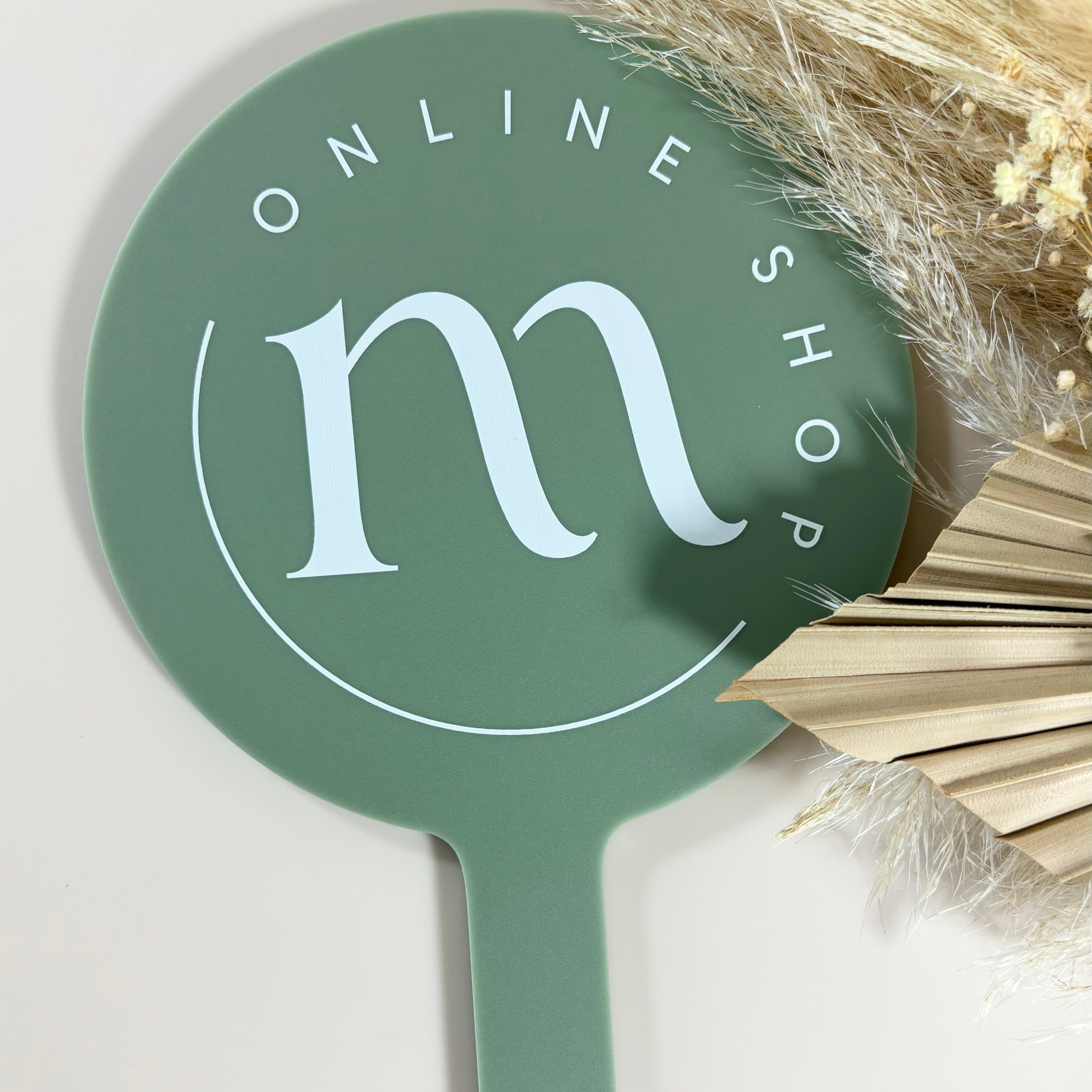 Green round salon mirror with custom m online shop branding