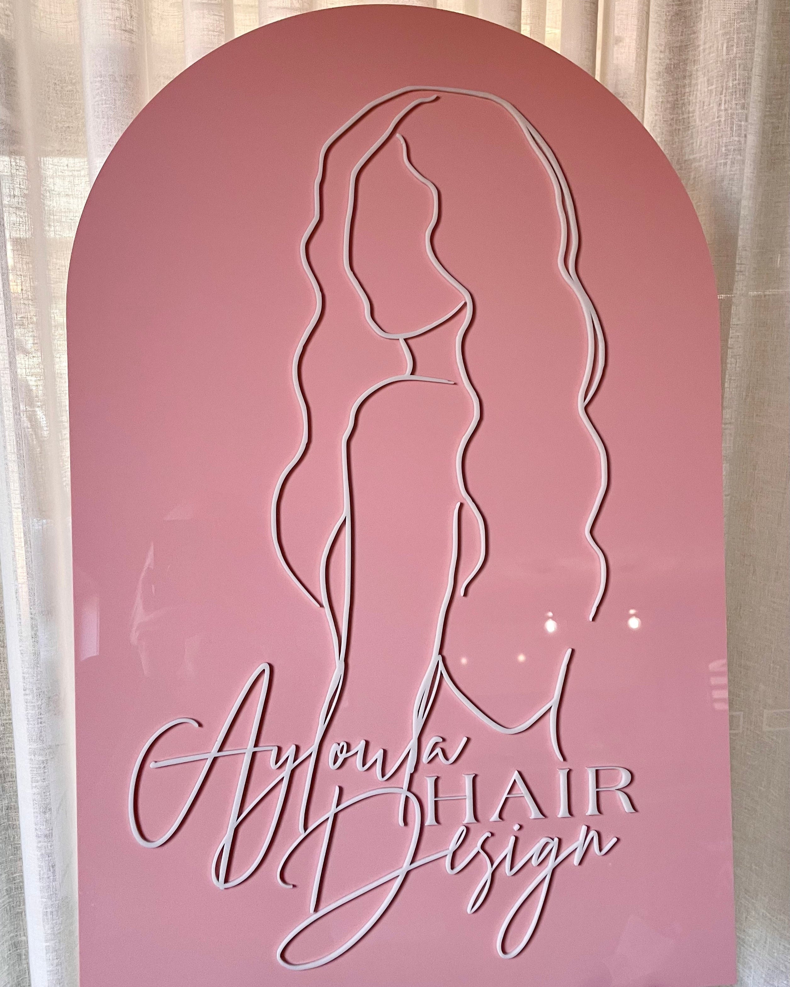 Blush pink arch sign with silhouette logo