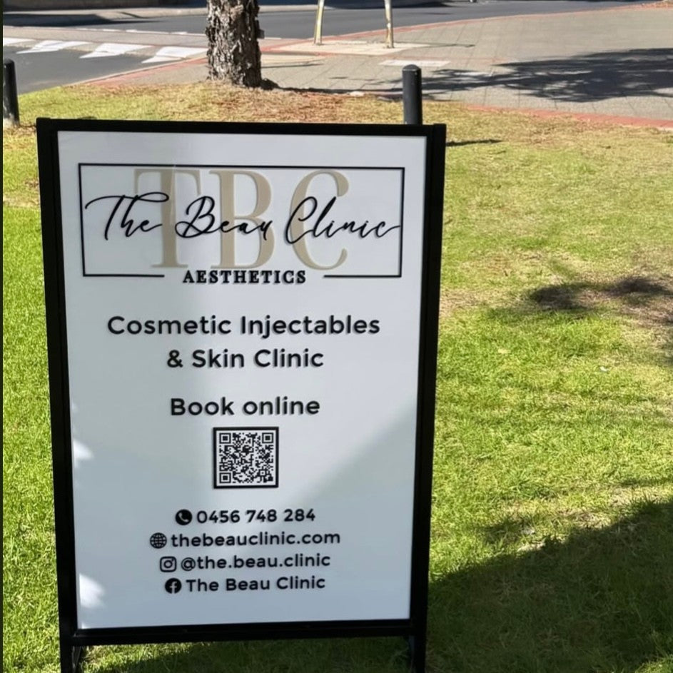 Custom portrait A-frame business sign with raised 3D acrylic lettering for a cosmetic injectables and skin clinic, featuring a clean white panel, black frame, and QR code for bookings, designed for outdoor shopfront advertising.