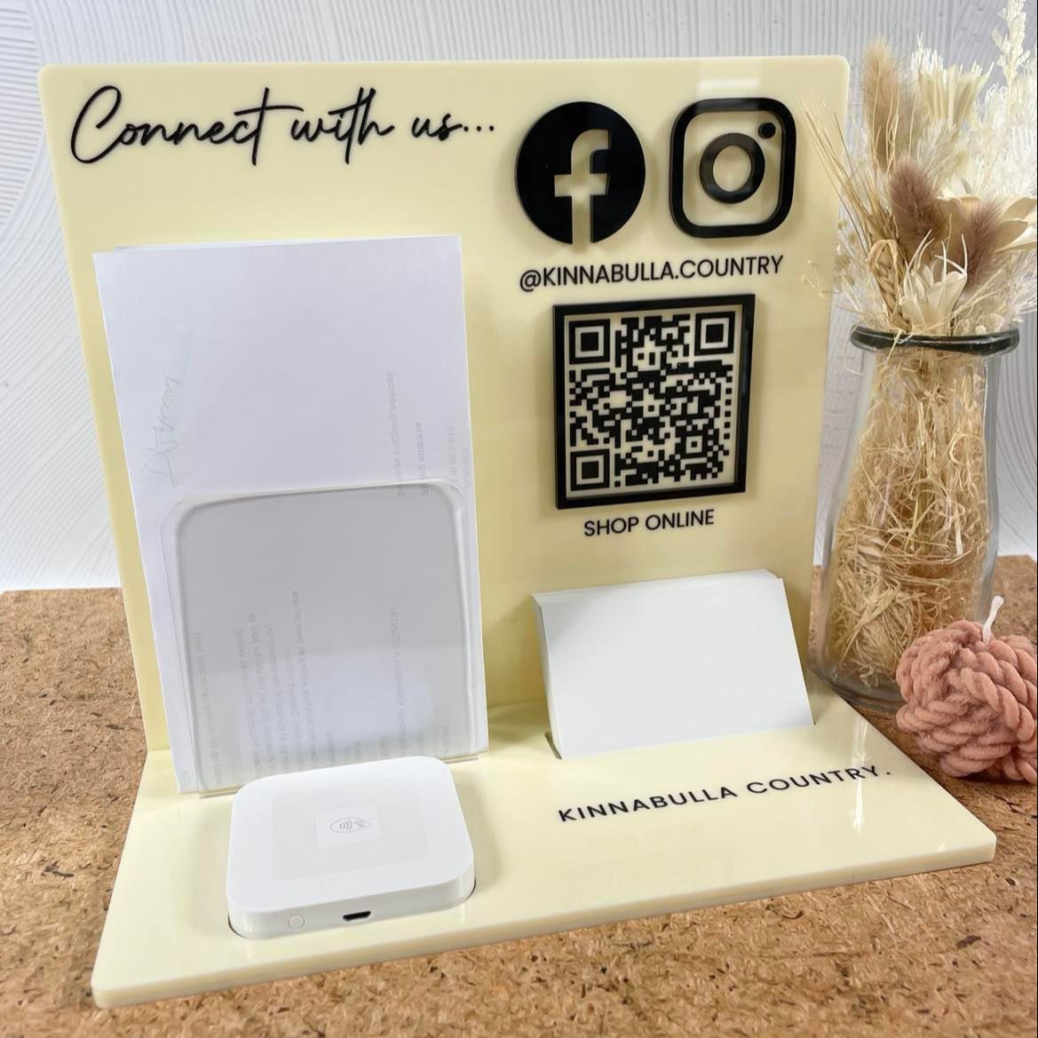 Cream acrylic business display stand with logo, brochure slot, and QR codes