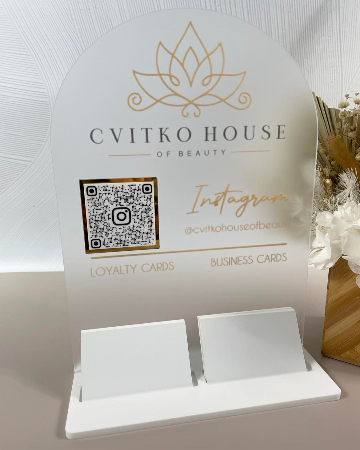 Frosted acrylic counter display with Cvítko House branding and QR code