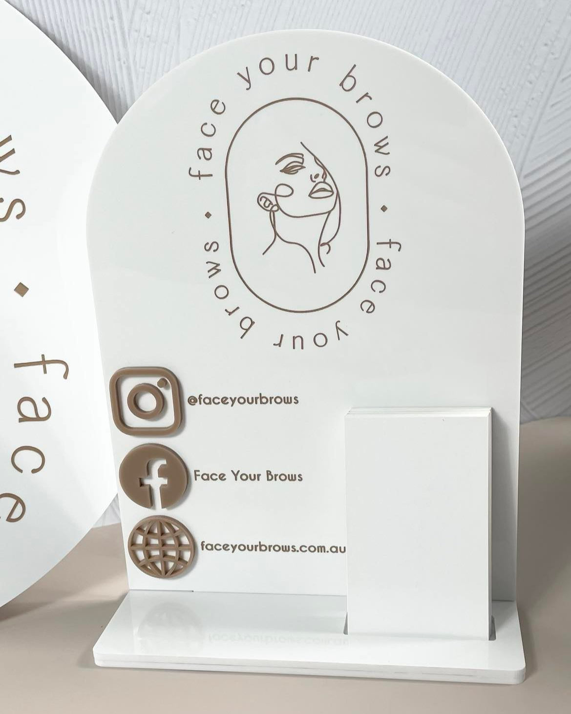 White acrylic social media sign with business card holder and custom logo