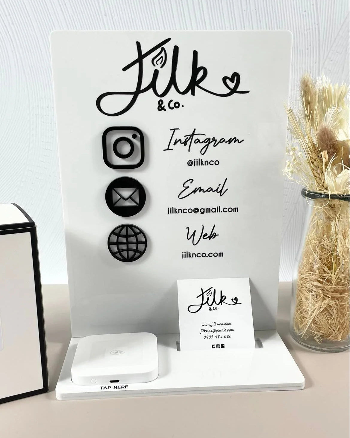 White acrylic business station with social media display and reader