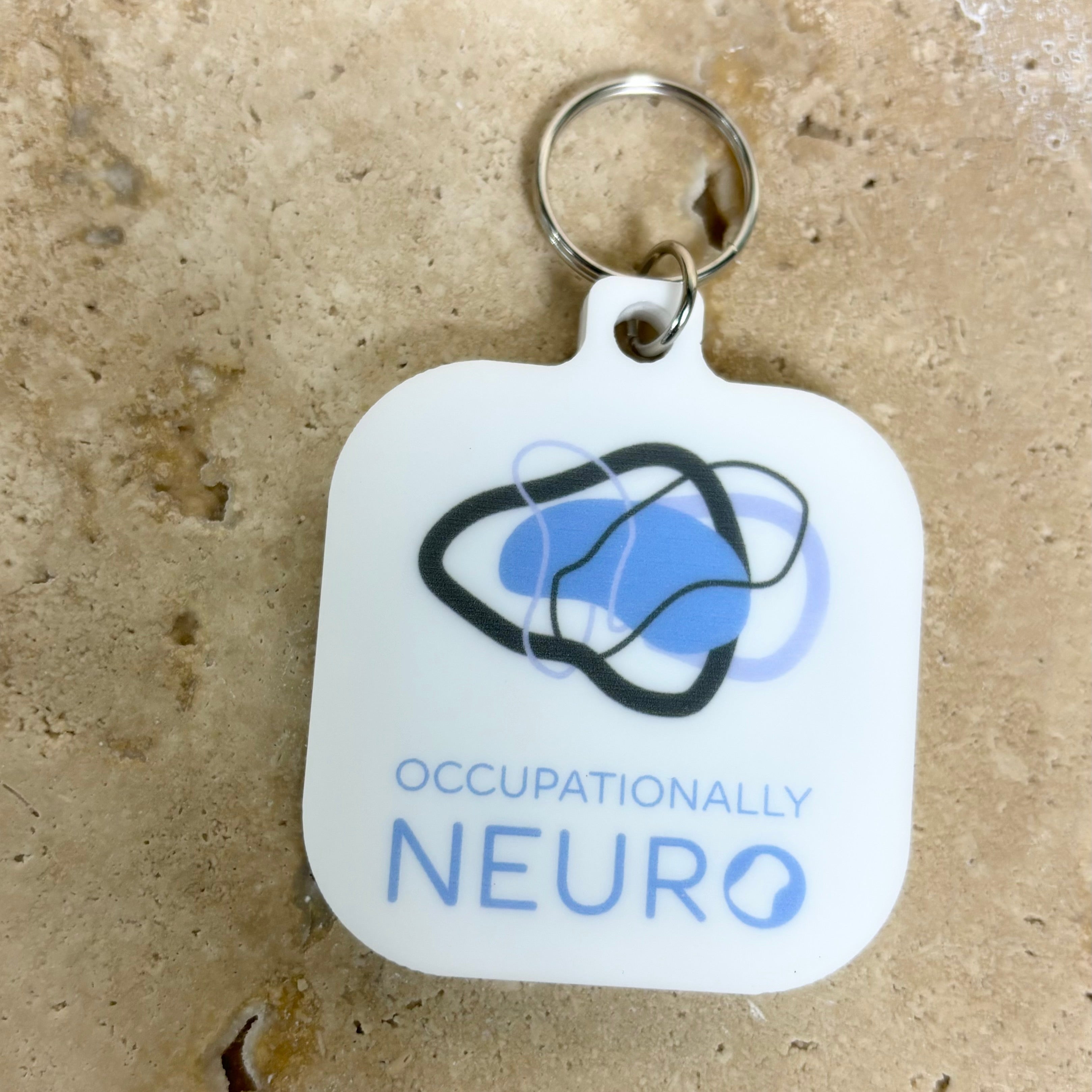 White branded NFC tag keychain with Occupationally Neuro logo