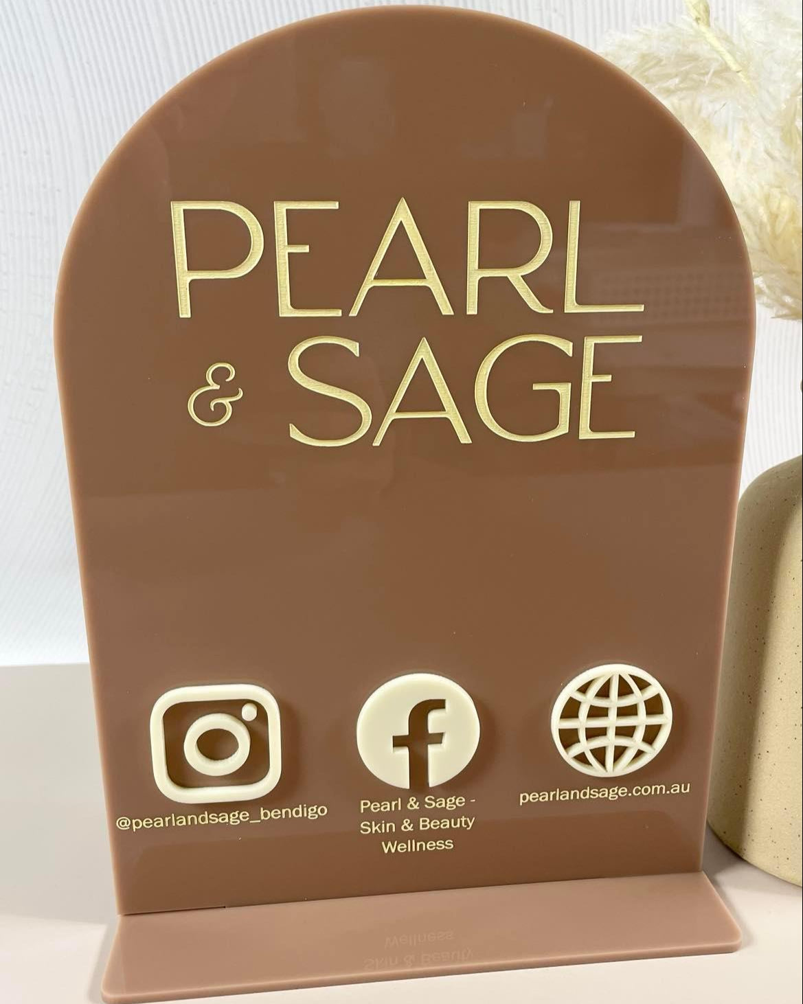 Custom brown acrylic social media stand for hair or beauty business
