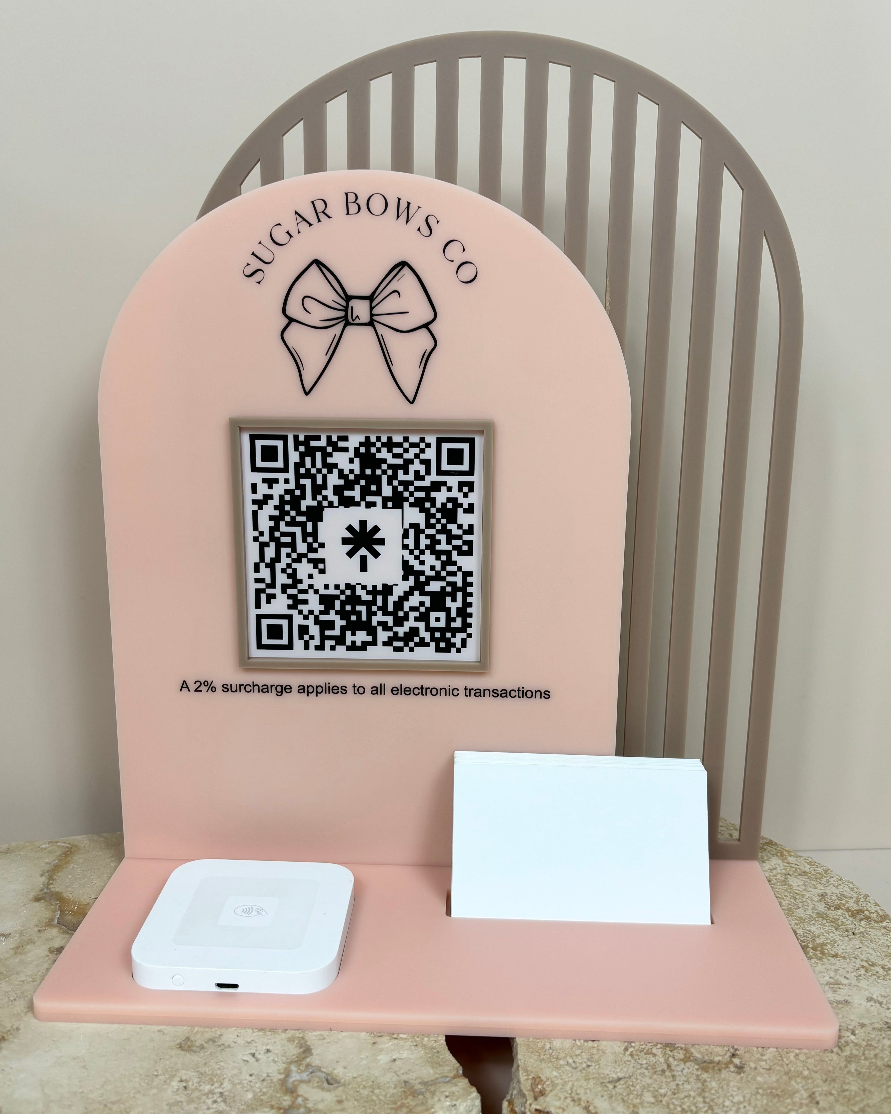 Pink acrylic social media display stand with icons and QR code