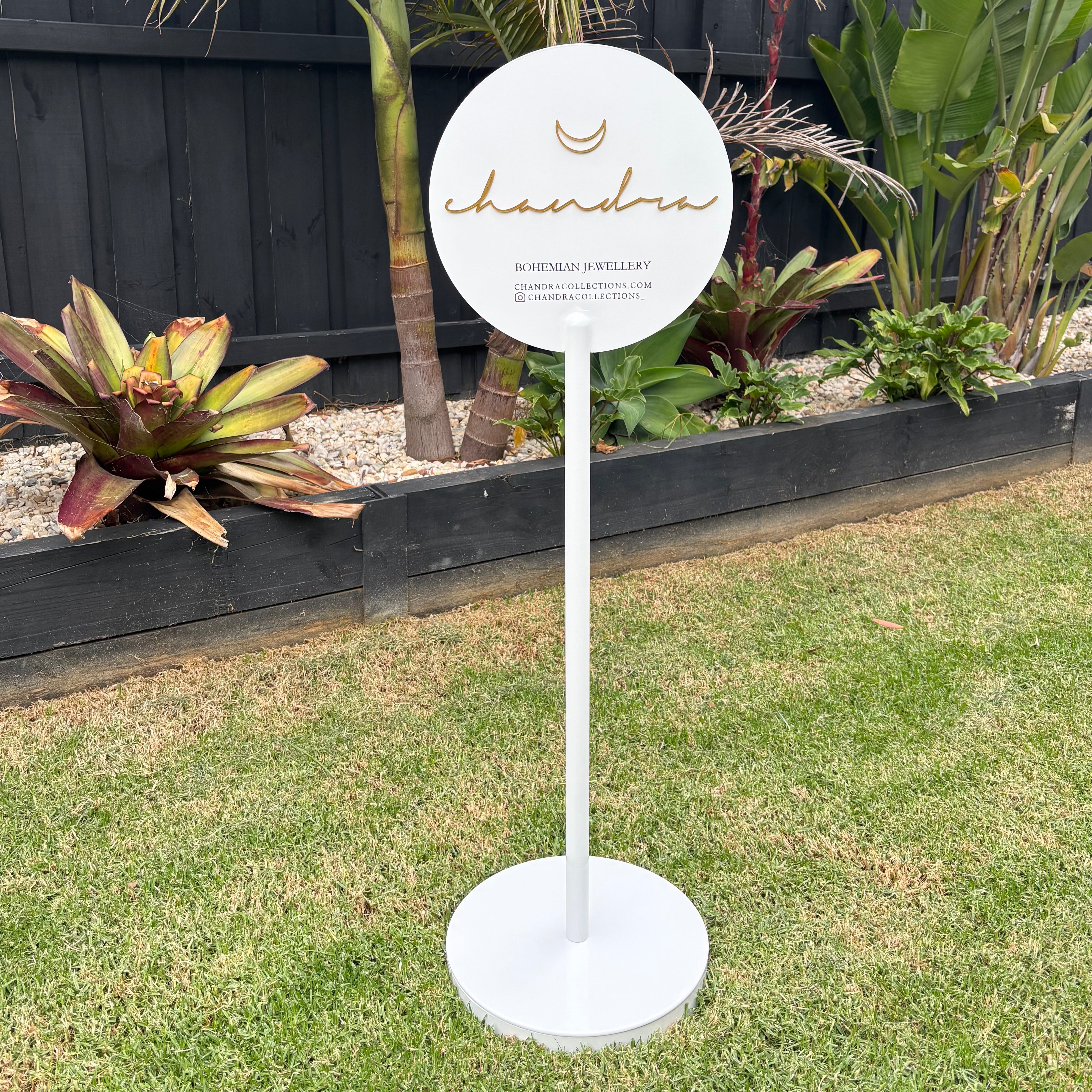 Freestanding round metal floor sign on stand in white, custom business branding sign with 3D acrylic lettering, outdoor advertising sign for small business storefront or event display