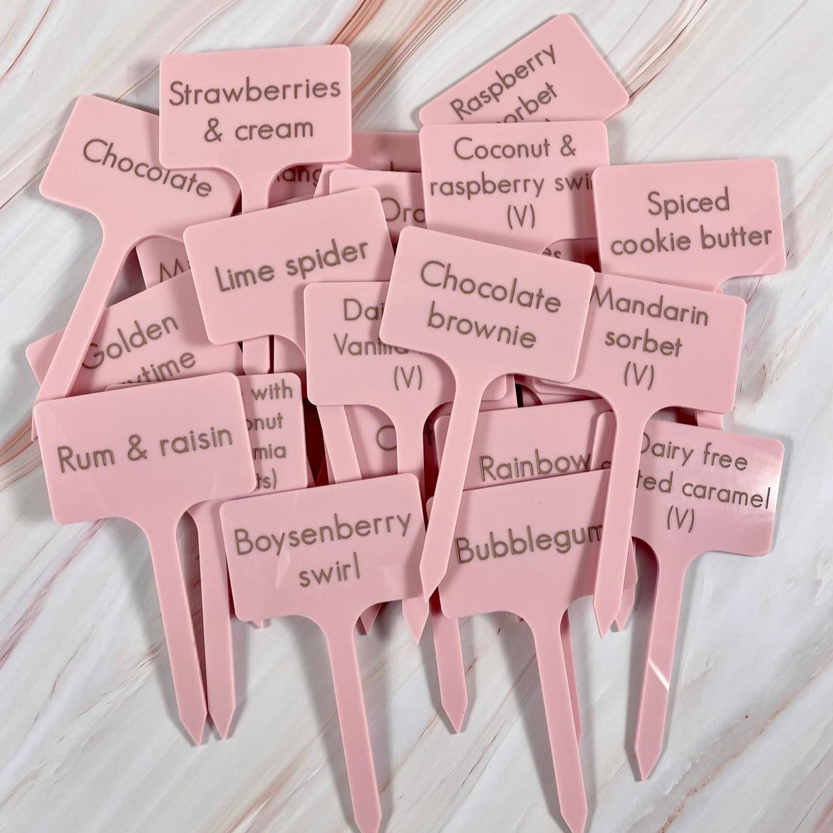 Set of engraved pink ice cream flavour sticks showing dessert names