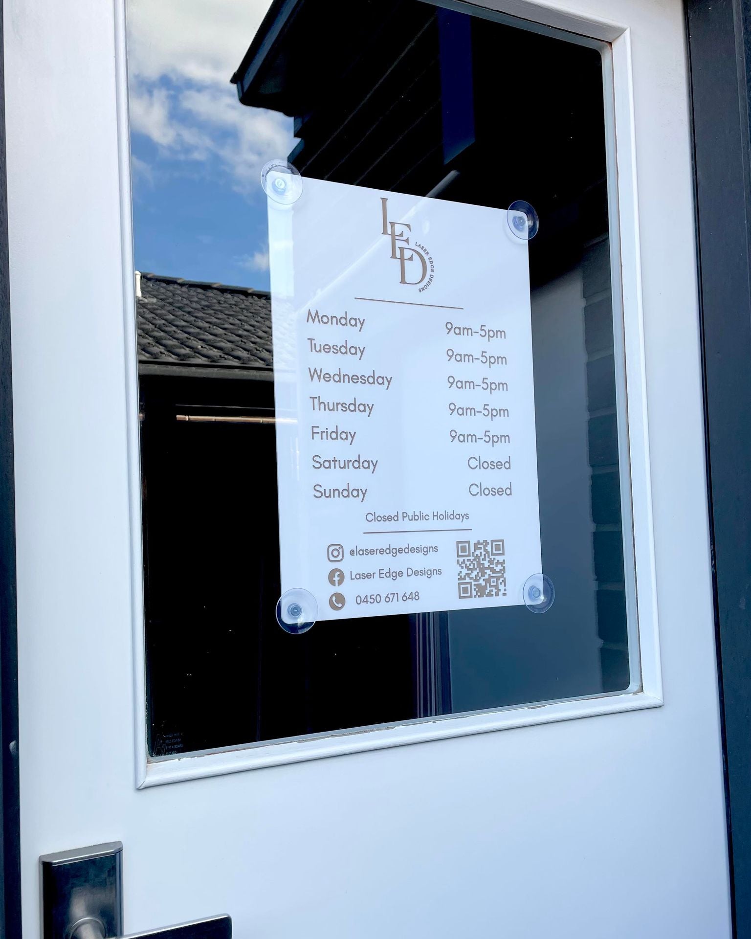 Customisable acrylic opening hours sign mounted on window, shop and salon signage