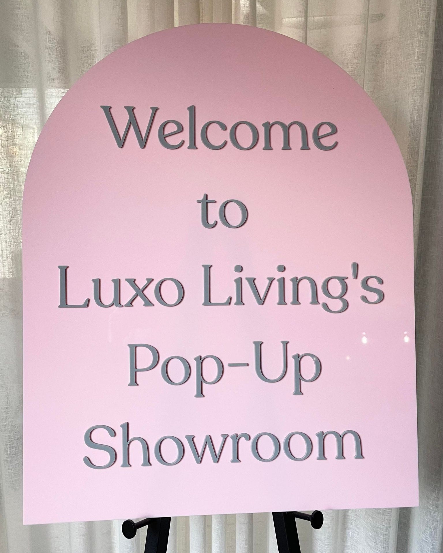 Pink arch showroom sign for pop-up store