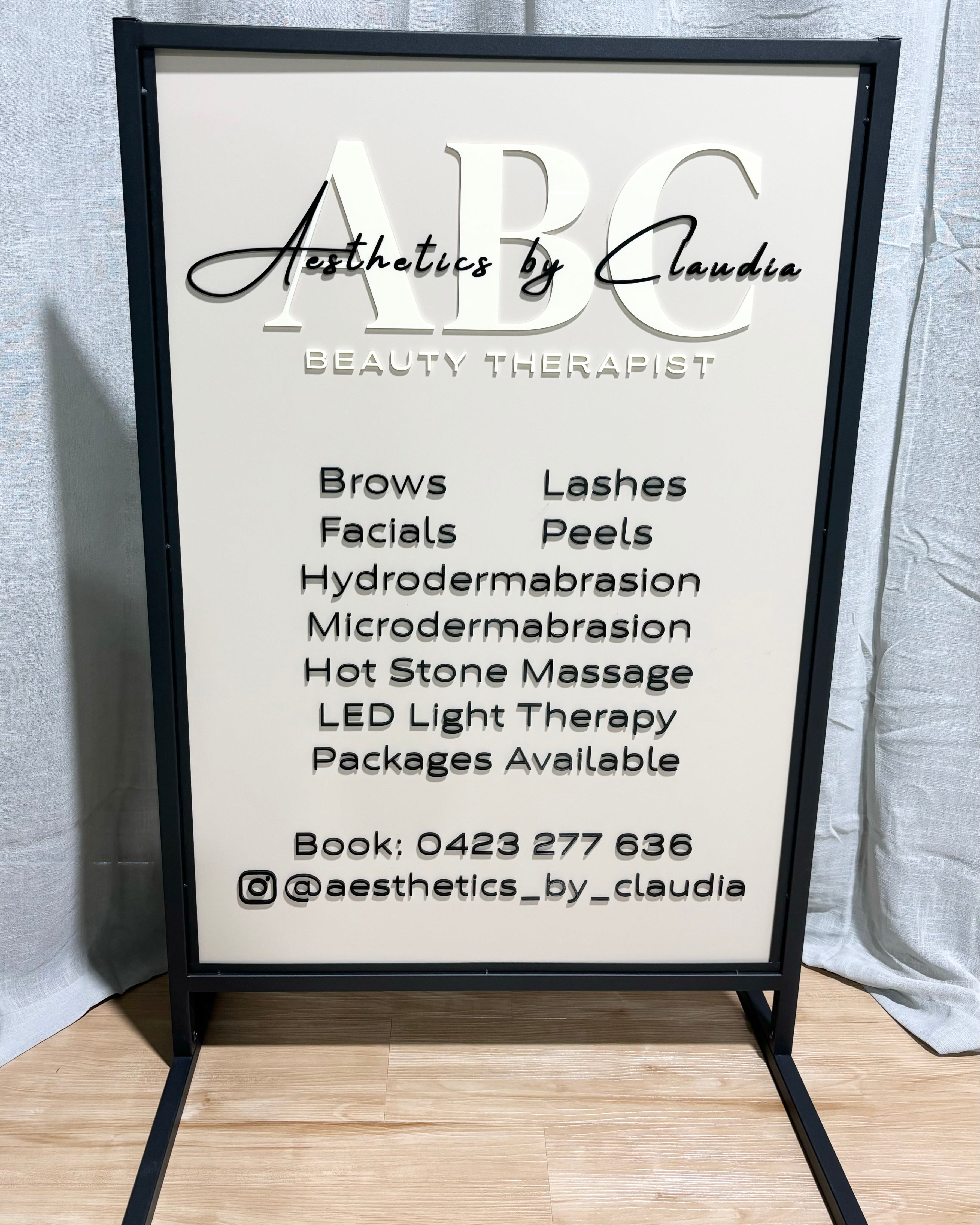 White framed T frame sign for aesthetic clinic services