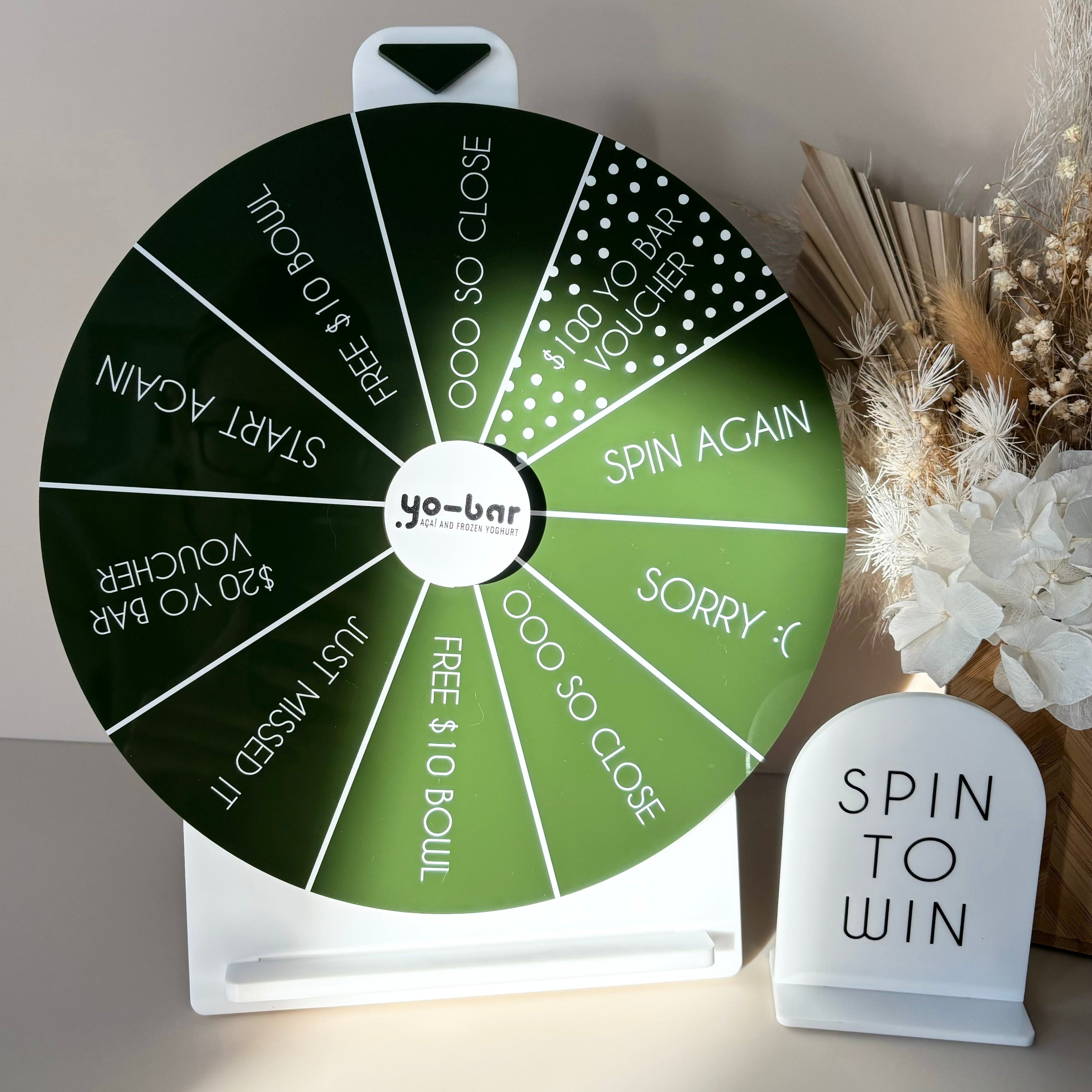 Green spin to win wheel with custom rewards for business events