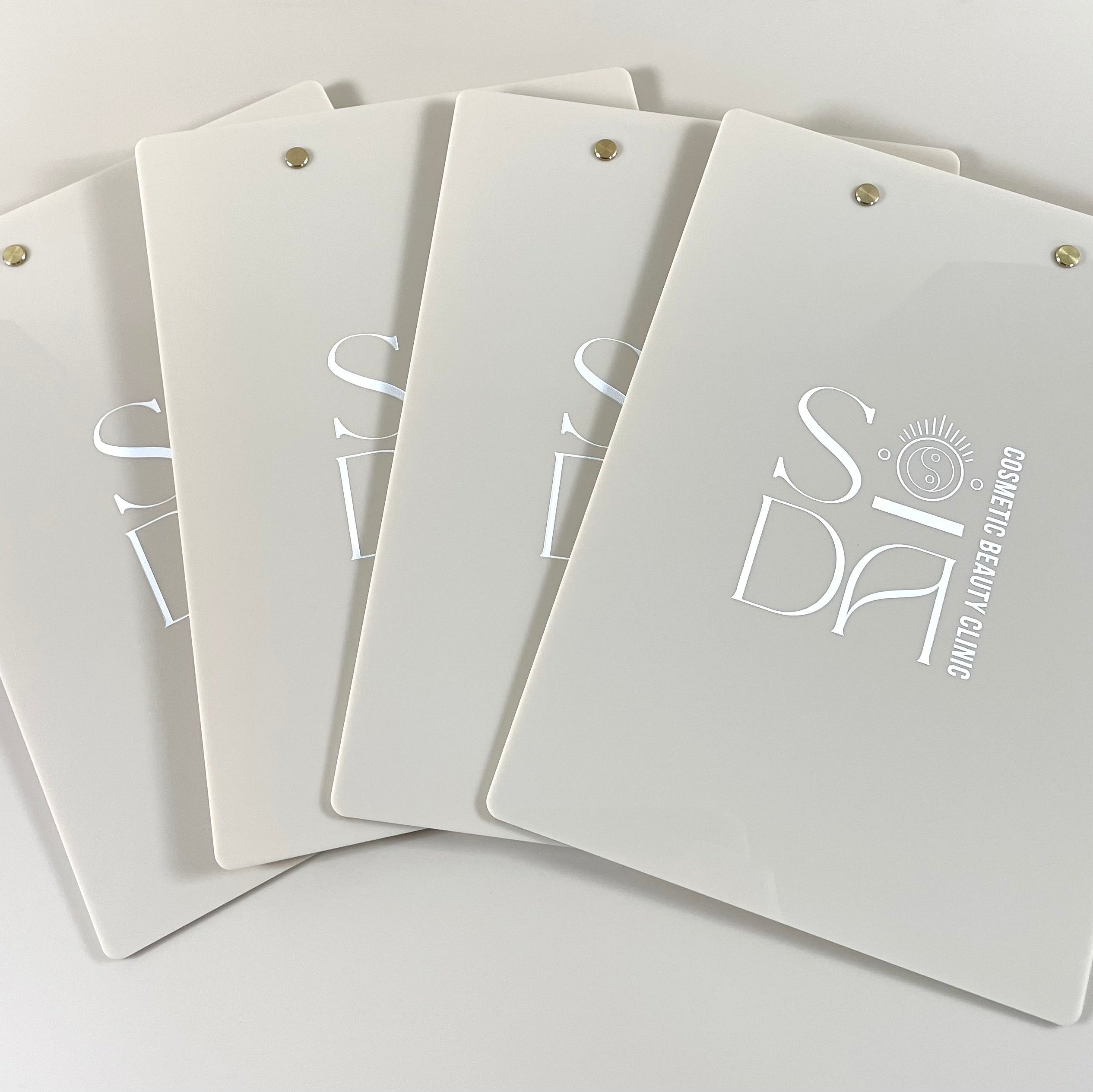 Beige branded clipboards with printed logo for salon or studio