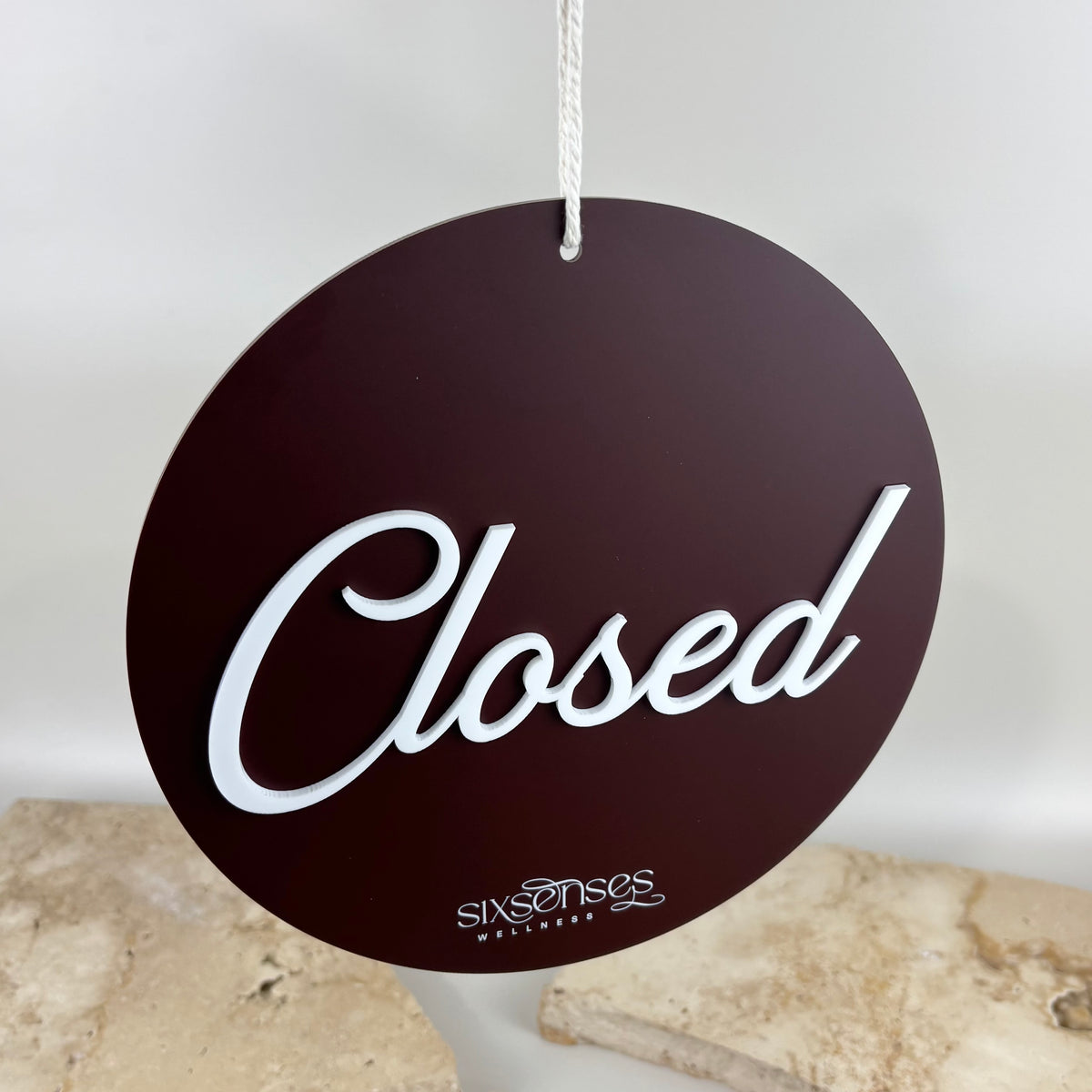 Custom round acrylic closed business sign with raised 3D lettering and printed logo, designed for salon, spa, clinic or shop doors.