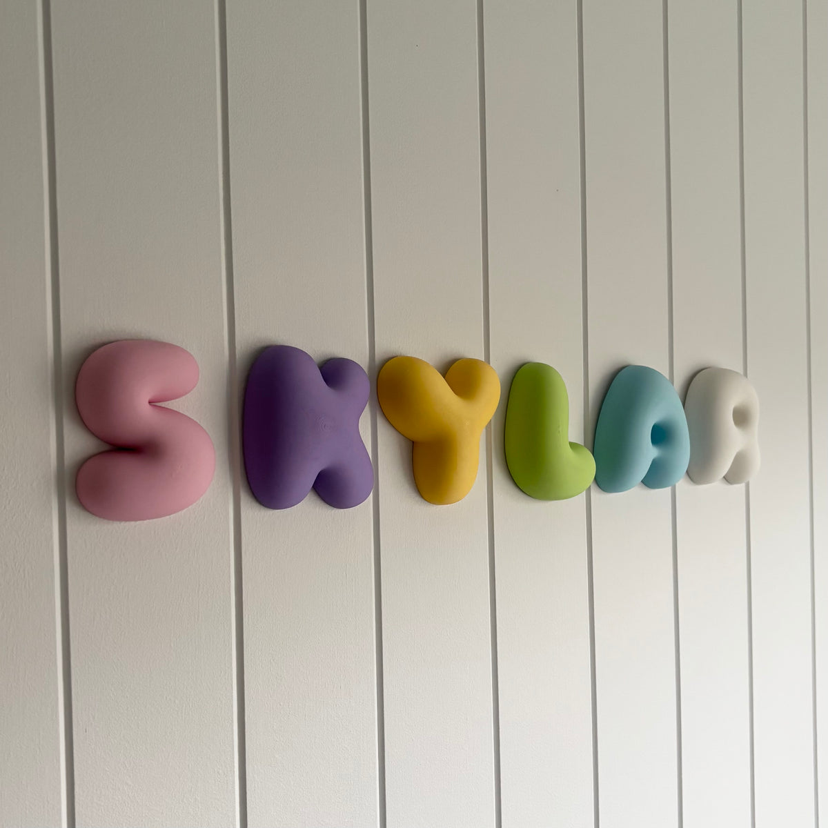 3D printed bubble name wall sign in colourful chunky lettering, personalised for kids’ bedrooms, nurseries and playrooms.