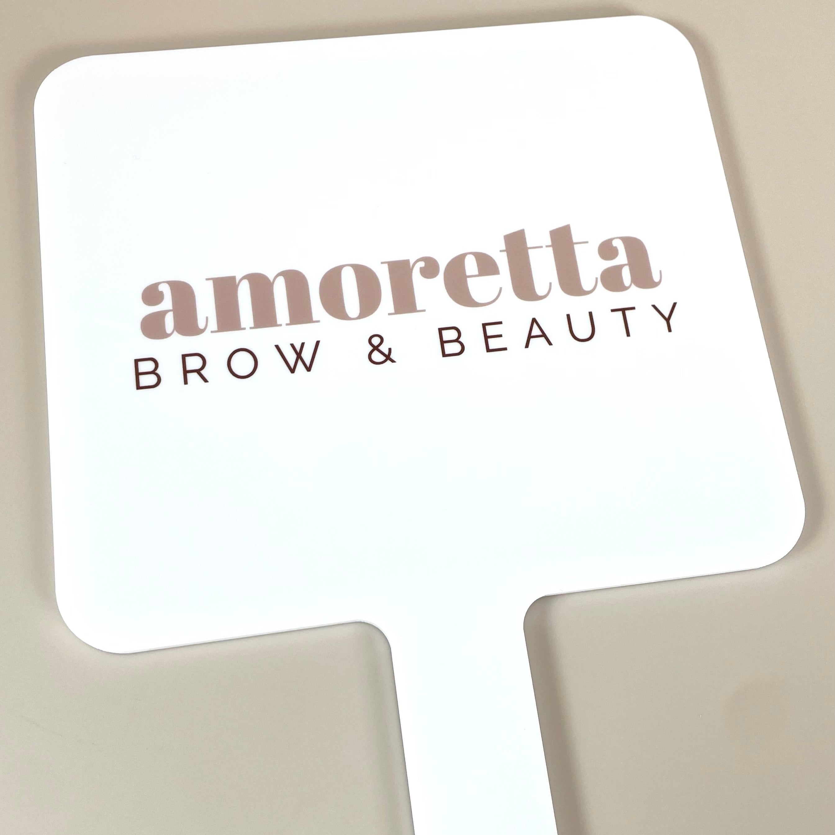 Amoretta Brow and Beauty logo on custom handheld mirror