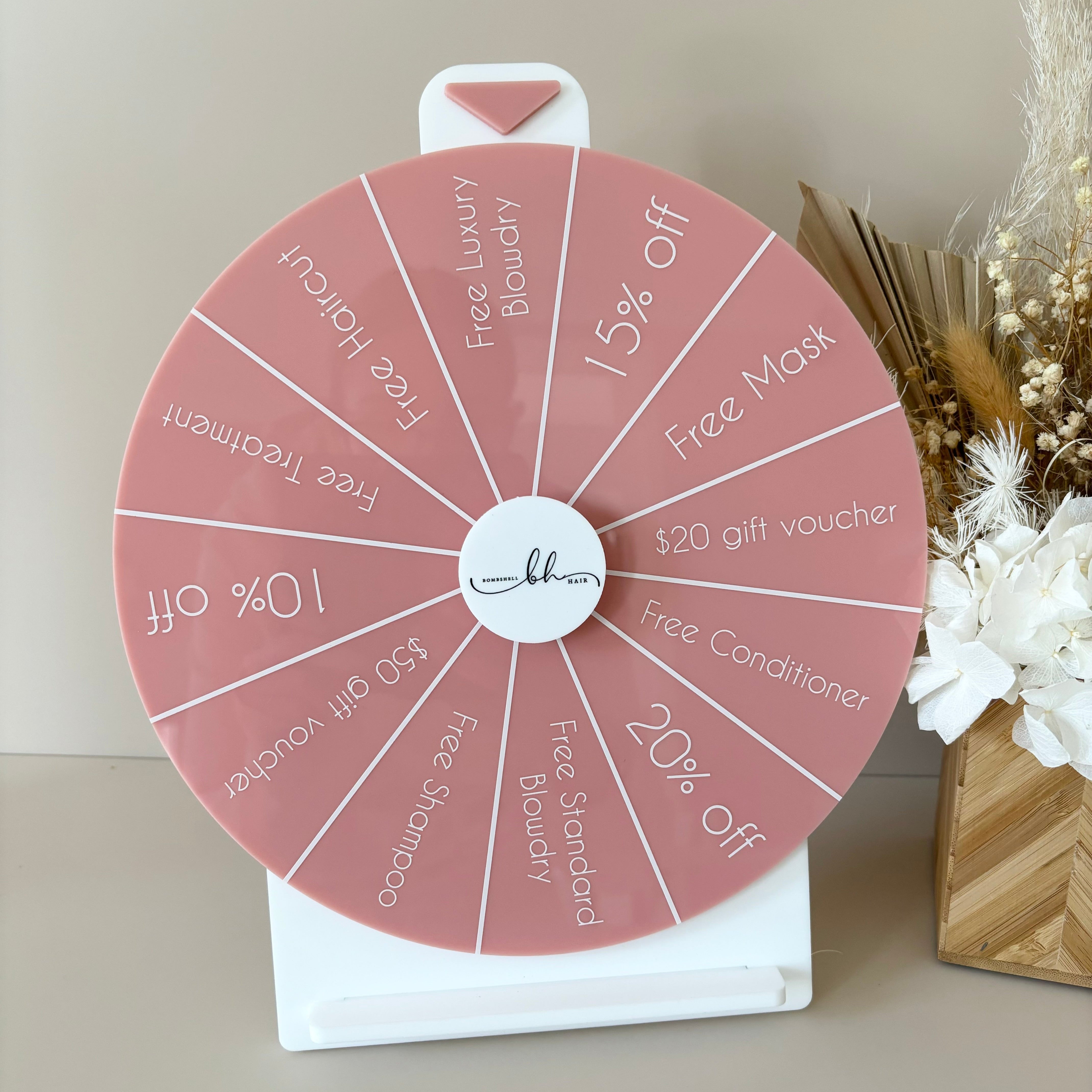 Pink acrylic prize wheel with custom sections for business marketing