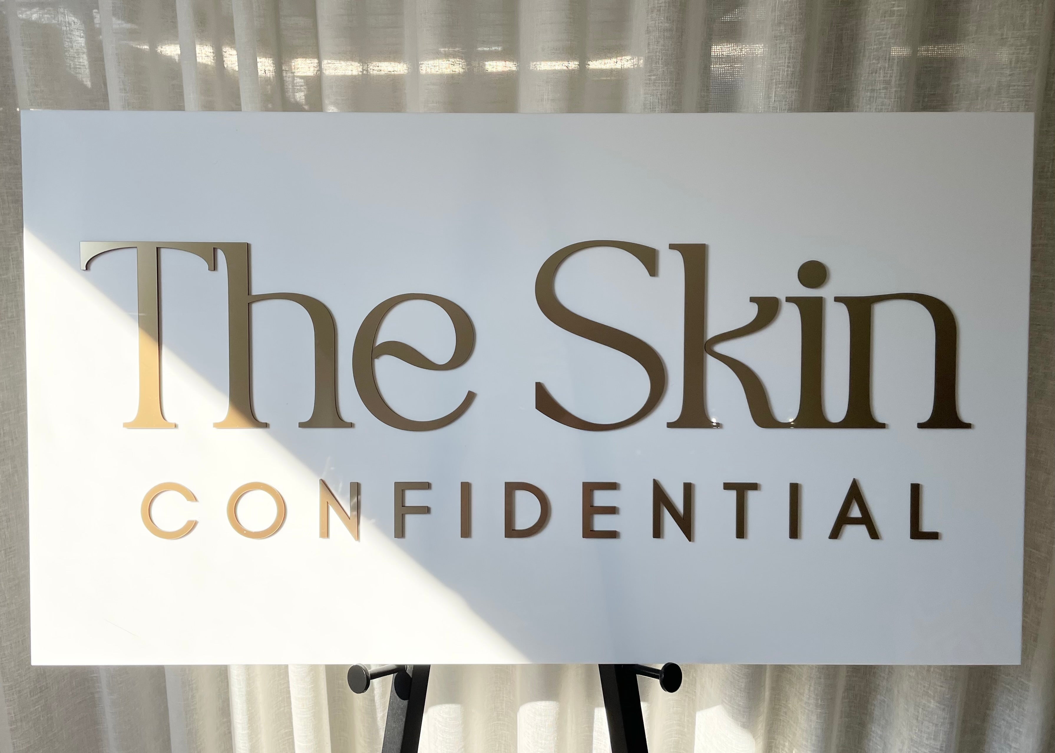 Modern branding sign for The Skin Confidential