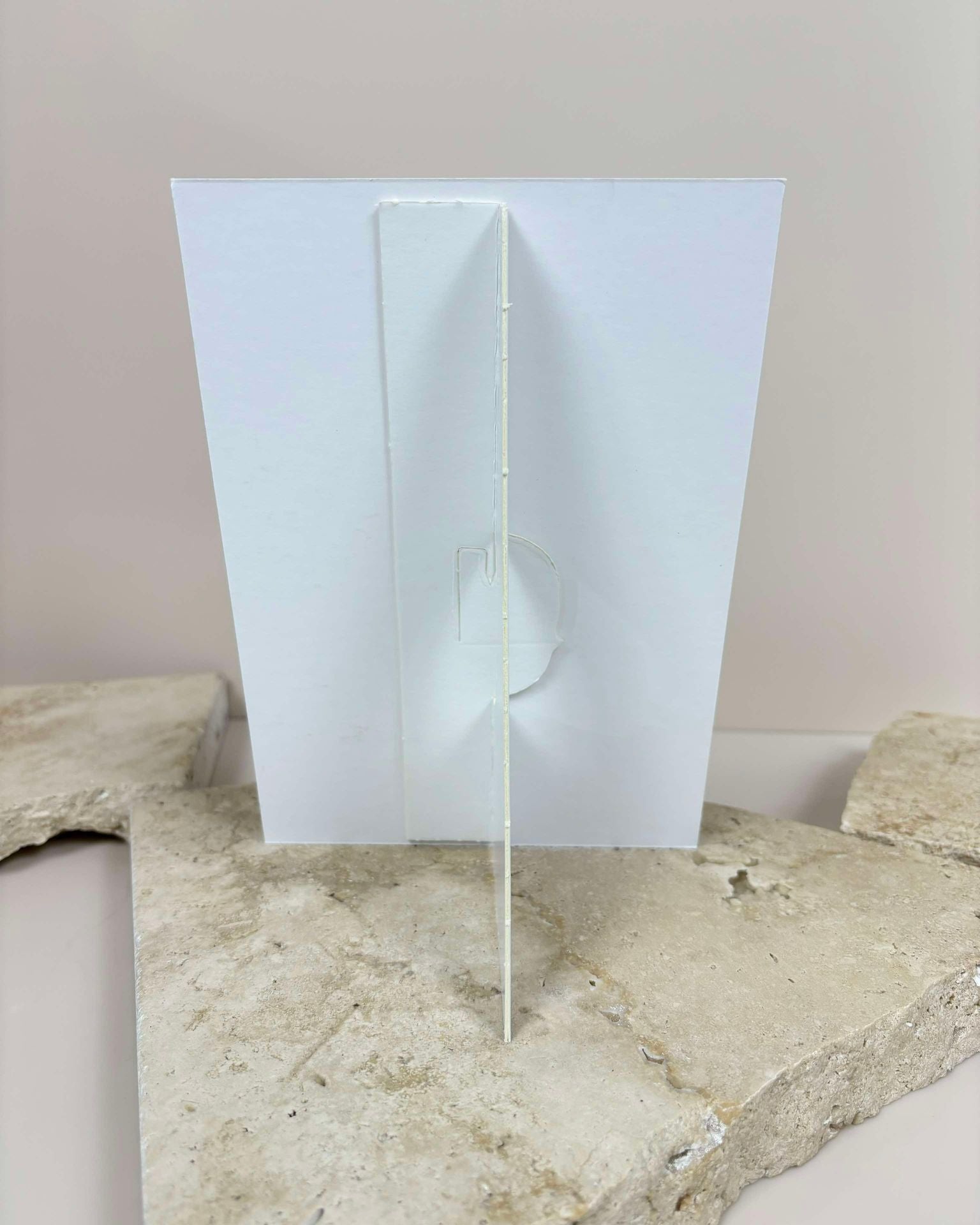 Back view of white screen board display stand with slotted base design