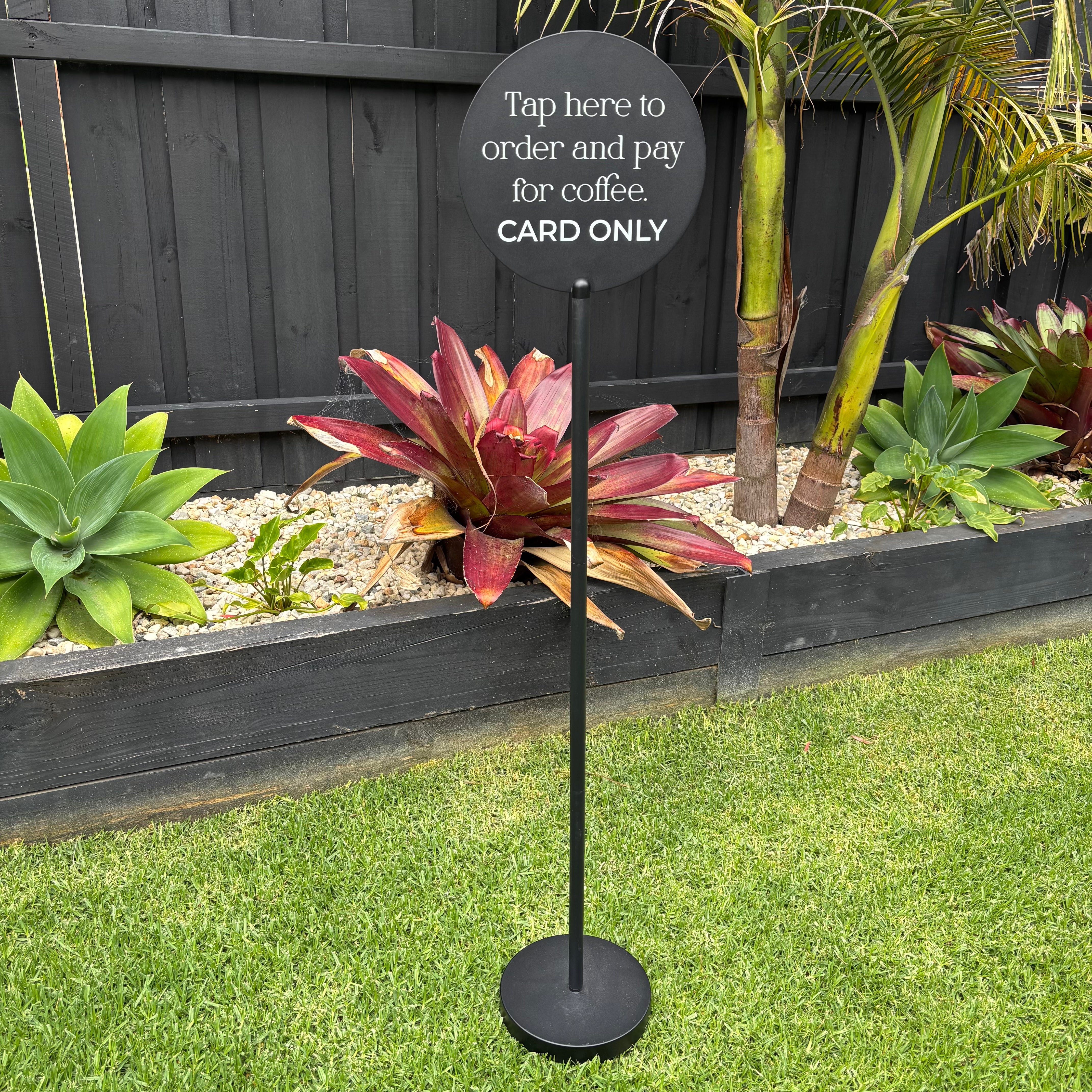 Freestanding metal floor sign stand for cafés and hospitality venues, featuring a round acrylic sign used for contactless ordering and payment instructions