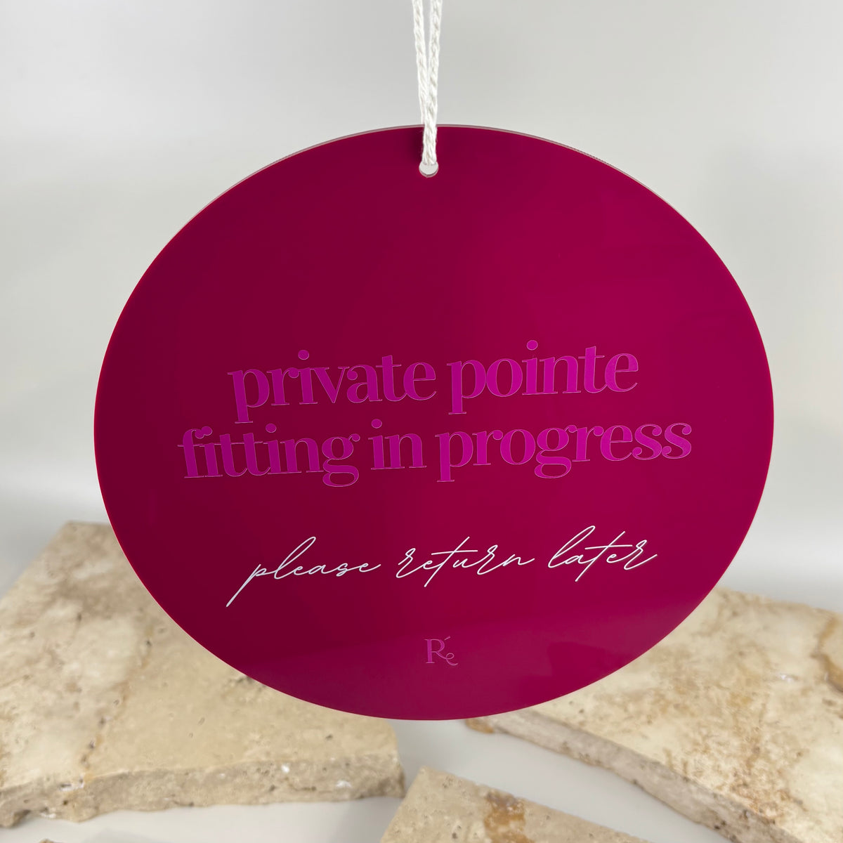 Round acrylic treatment room door sign with “fitting in progress, please return later” text, ideal for salons, boutiques and private appointment spaces.