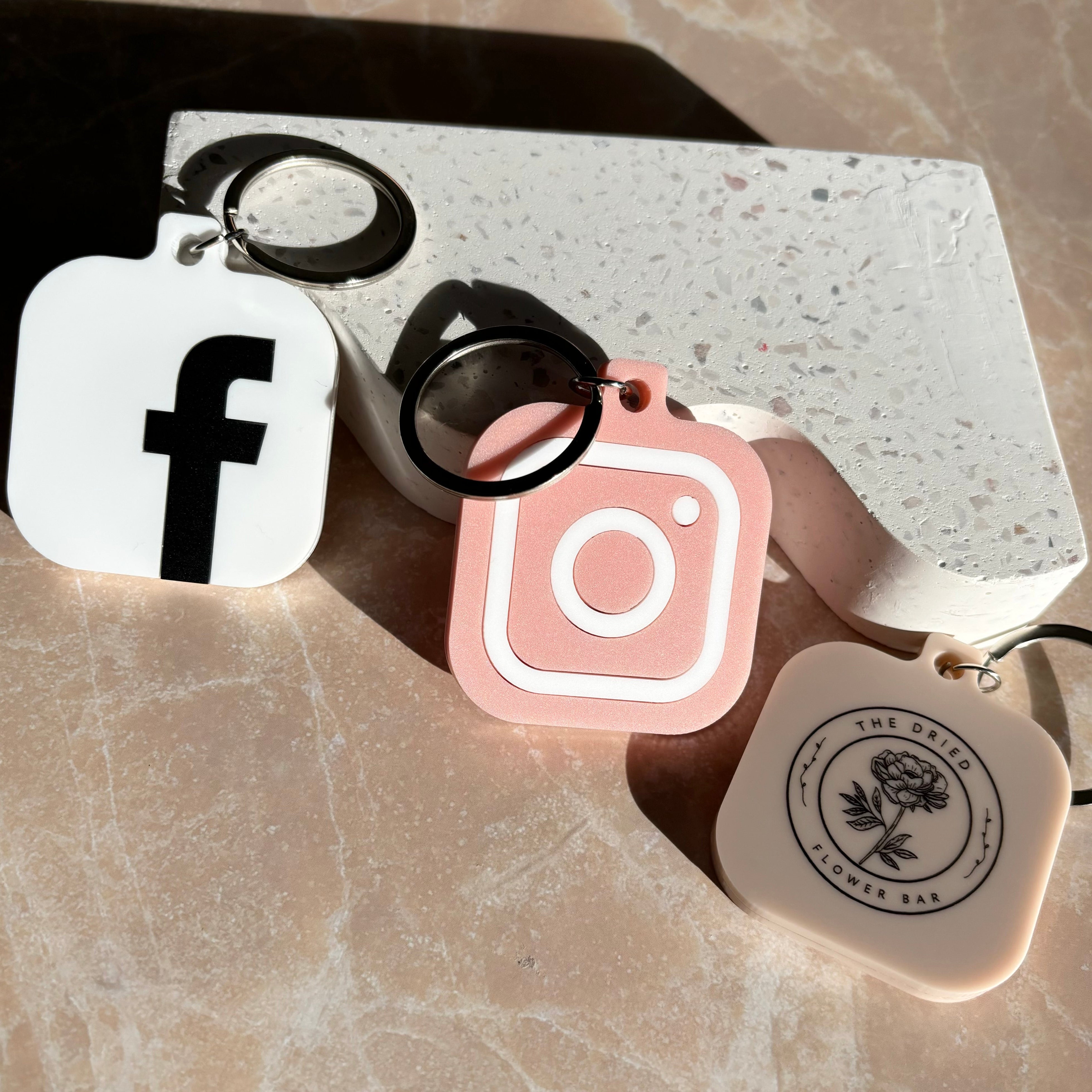 Black and white NFC keychain set with Facebook and Instagram icons