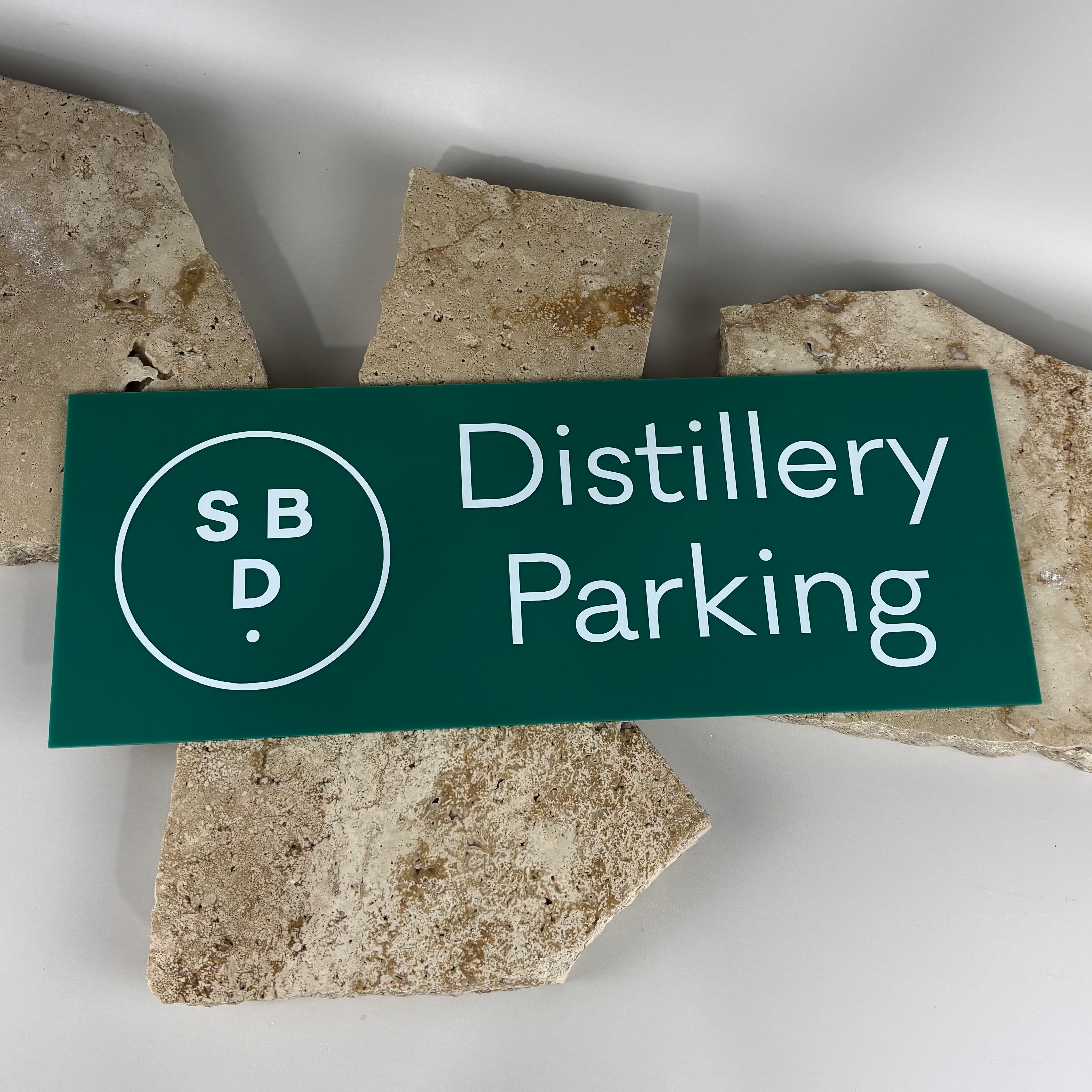 Custom acrylic distillery parking sign with logo, suitable for business car park and venue signage.