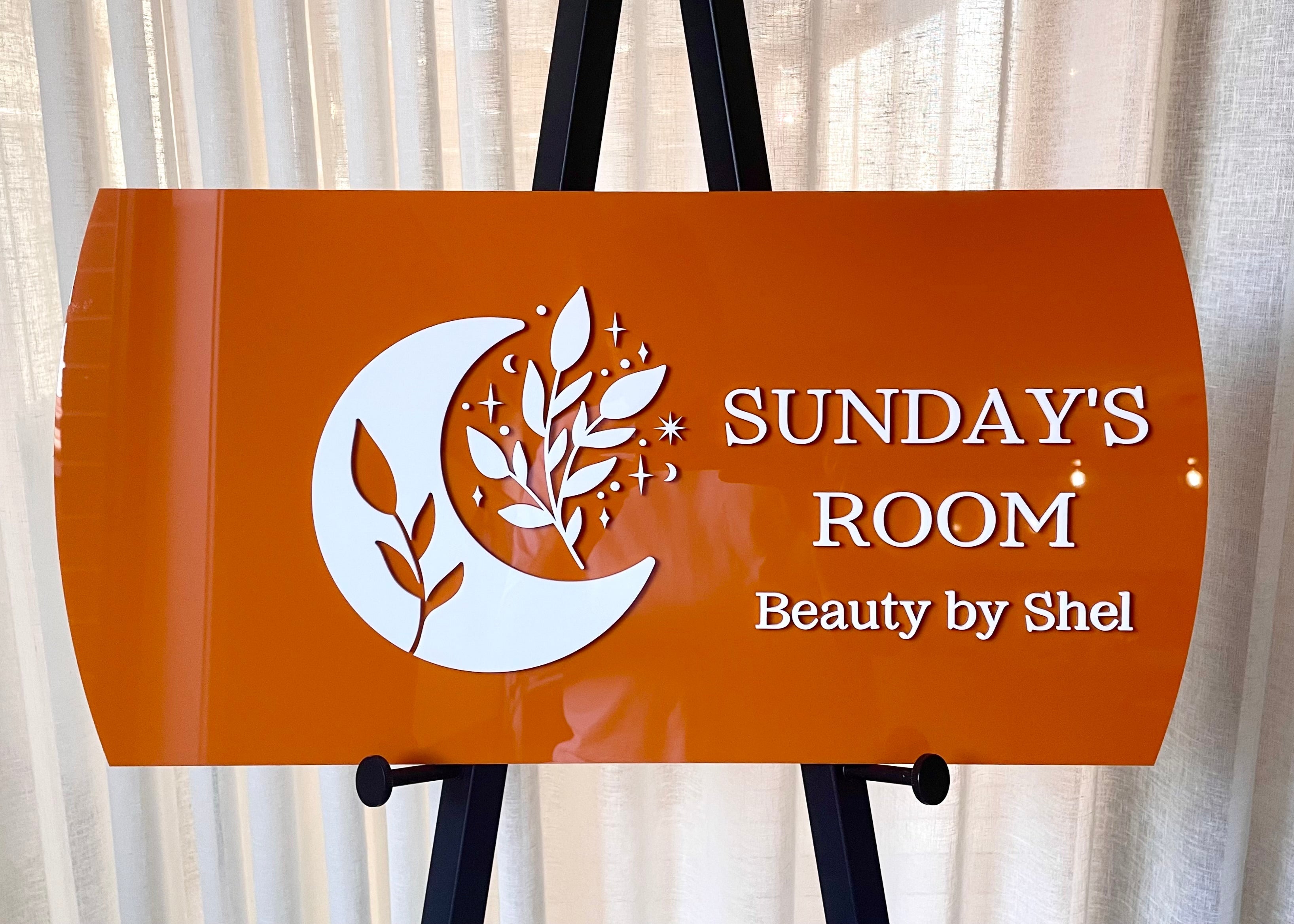 Burnt orange beauty sign for Sunday Room