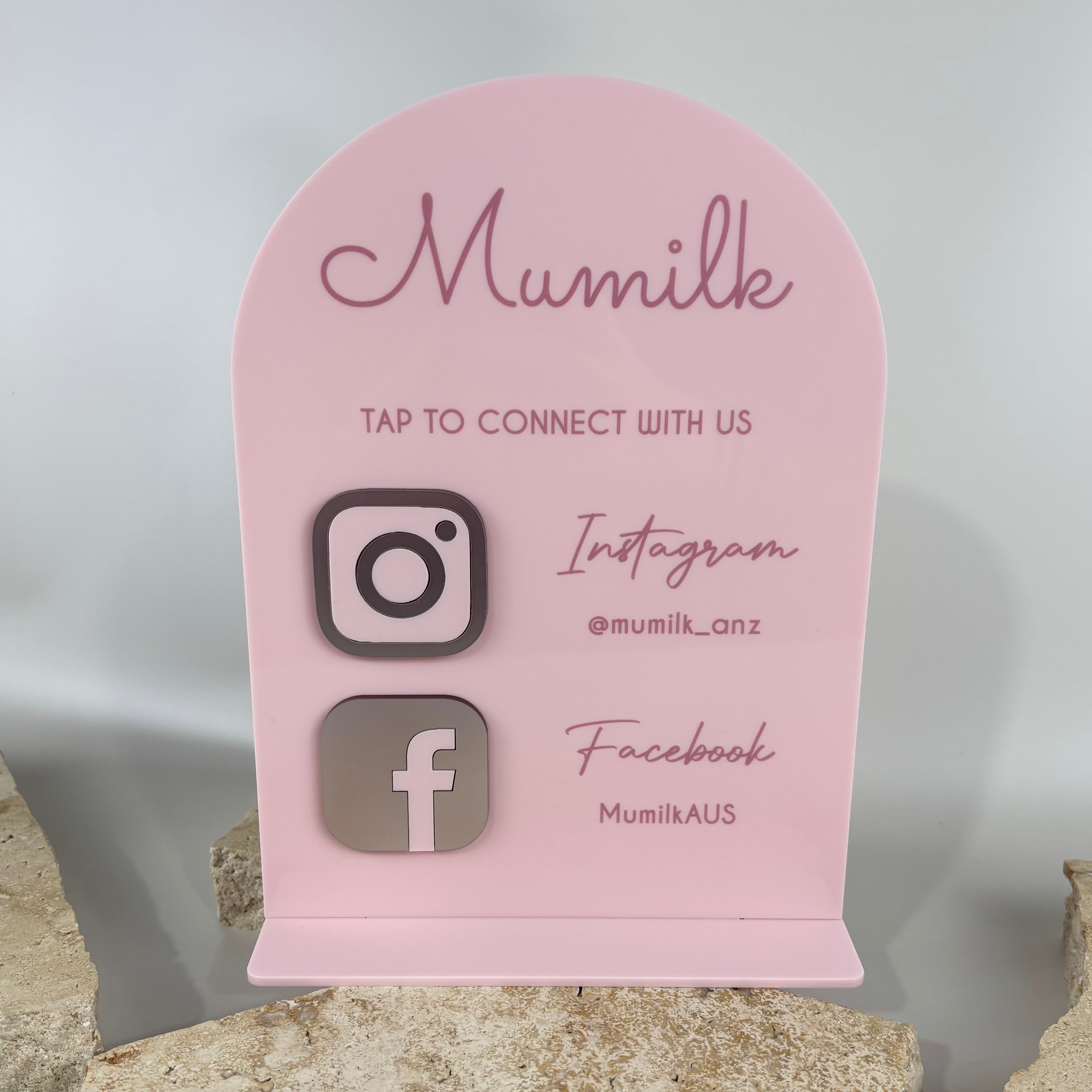 Pink acrylic NFC social media stand with Instagram and Facebook icons, customised branding for business counter display