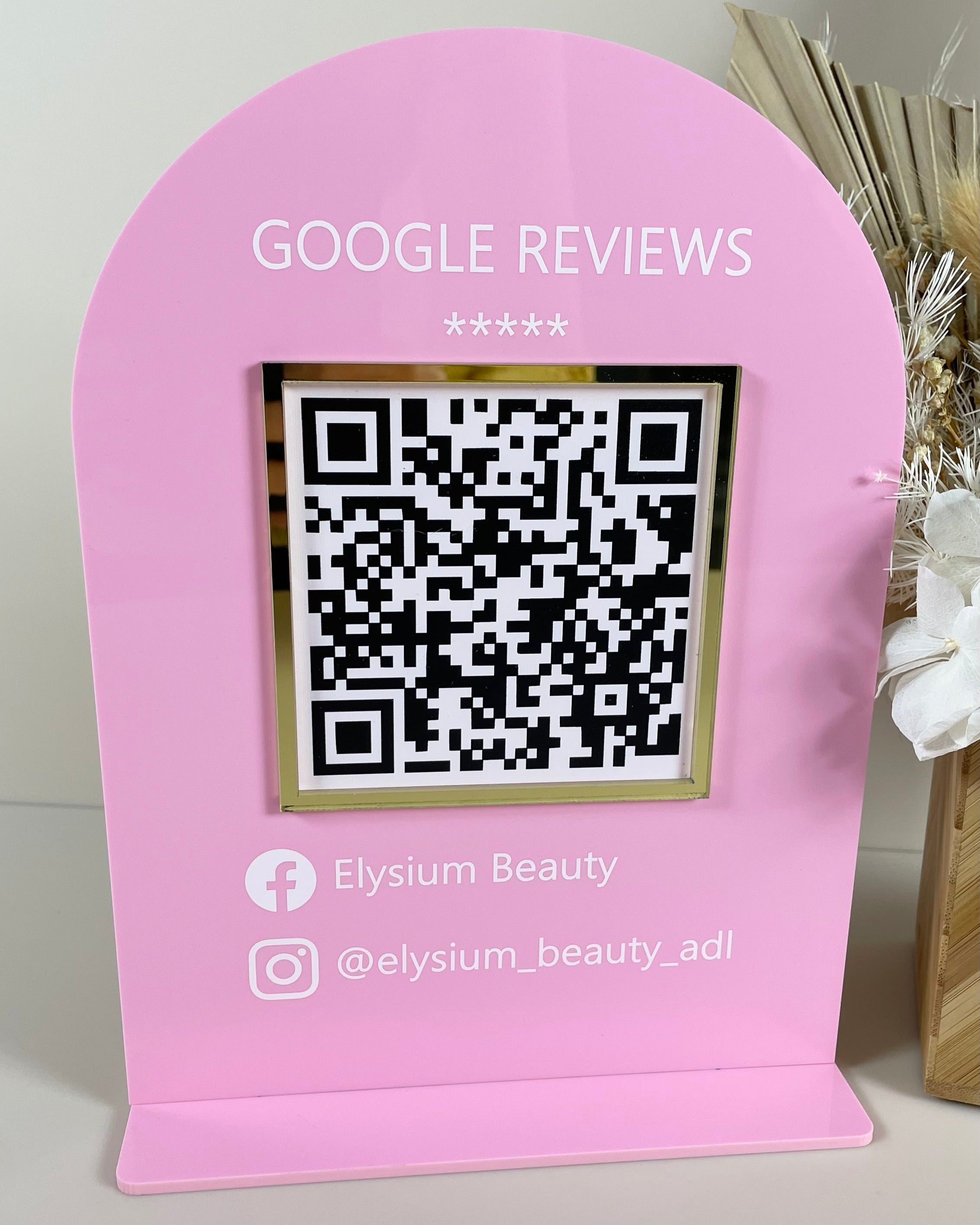 Pink Google review stand with business Instagram handle and QR code