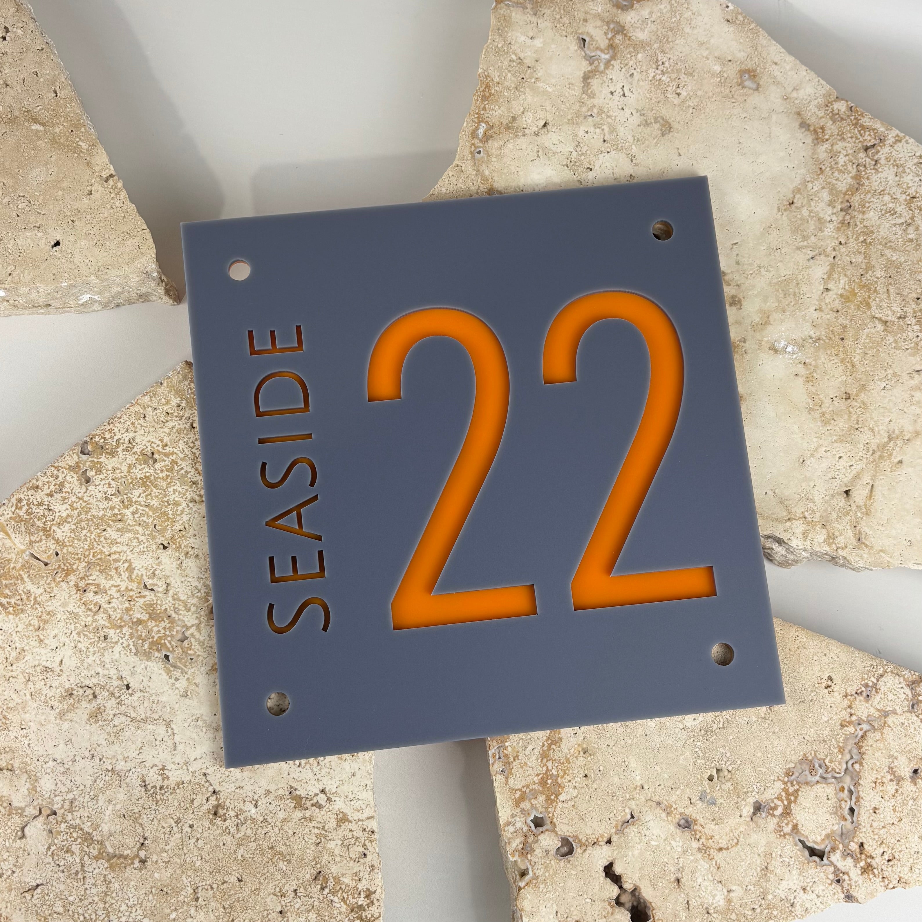 Modern acrylic house number sign with cut-out illuminated numbers, custom address plaque with street name, grey outdoor wall signage with bold orange number, durable personalised house sign Australia